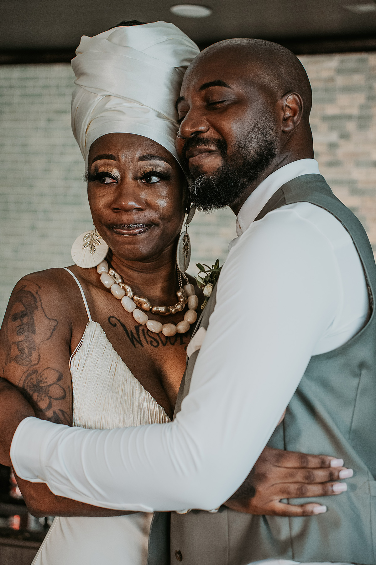 Groom's sister smiles with emotion after seeing him dressed for his wedding.