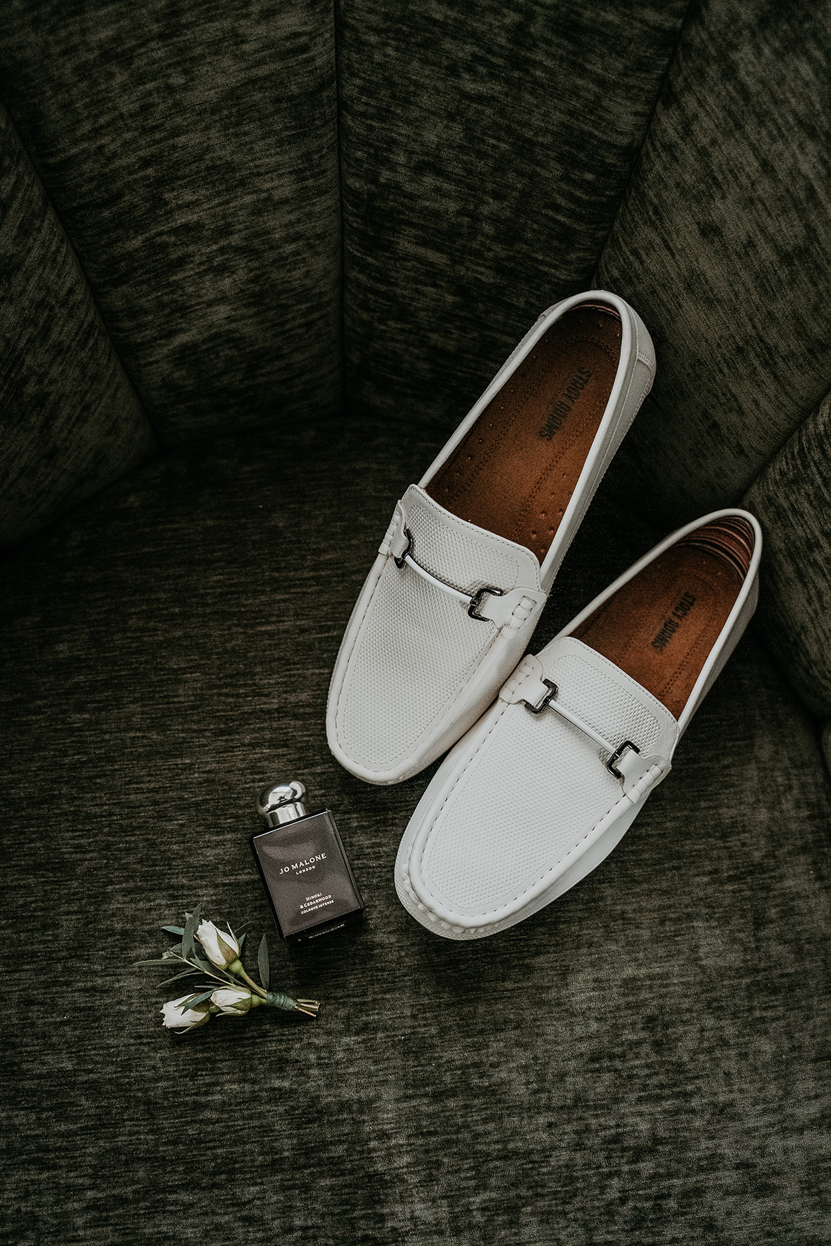 Close-up of a groom's wedding shoes and perfume before his Puerto Rico wedding.