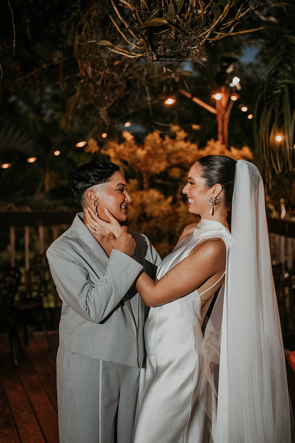 Newlywed couple laughing during their wedding reception