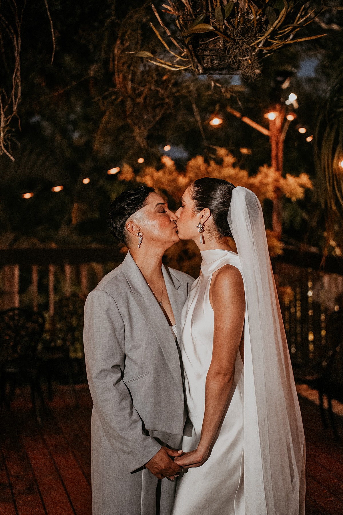 Two brides sharing a kiss during micro wedding reception