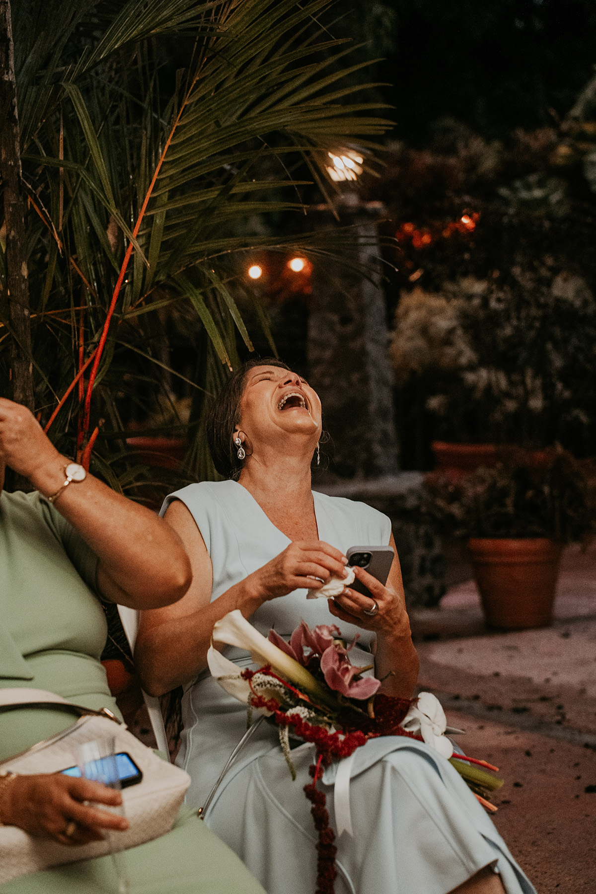 Wedding guests laughing together during the reception