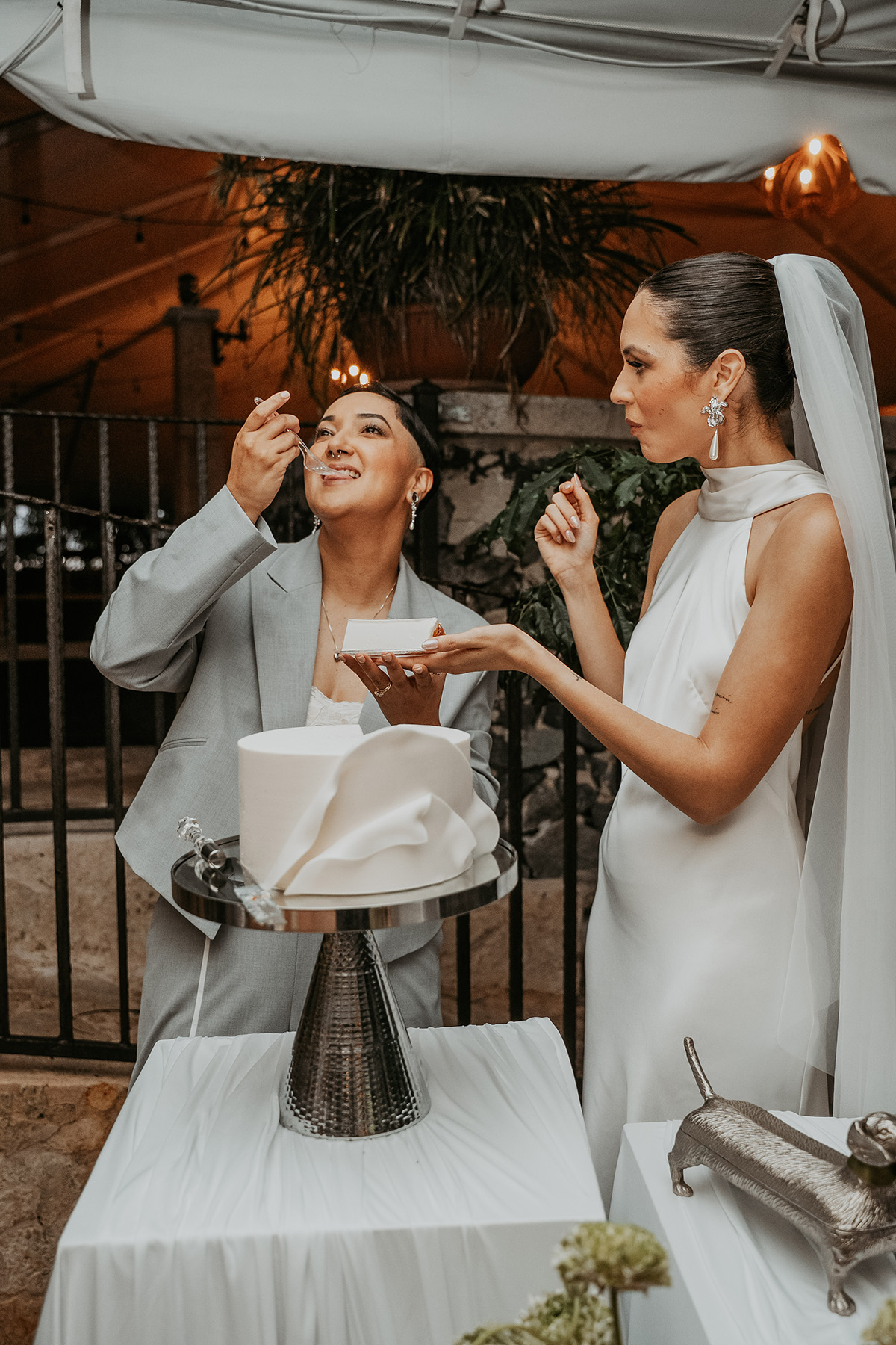 Couple sharing a moment while tasting their wedding cake