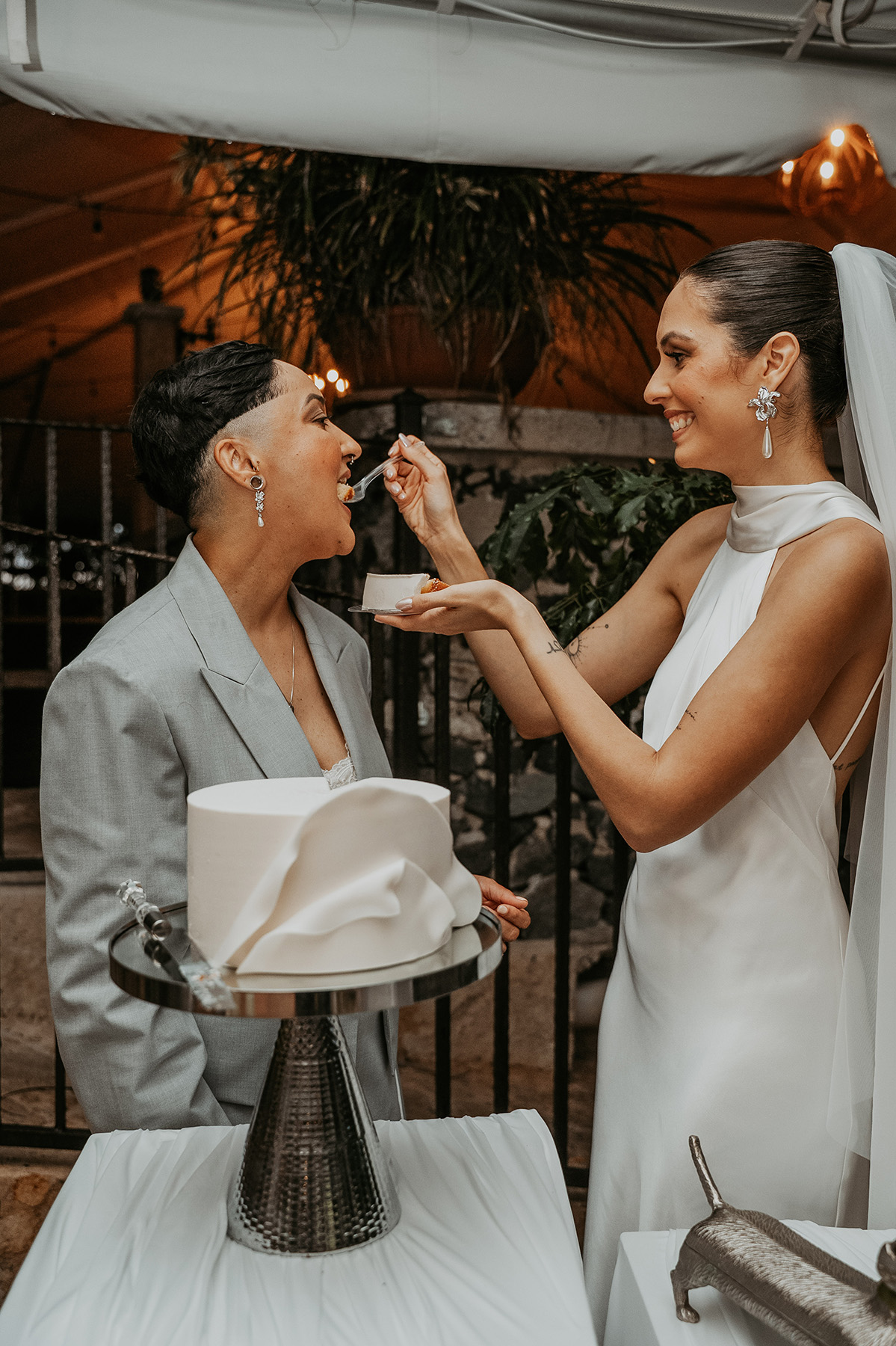 Newlywed couple tasting their wedding cake