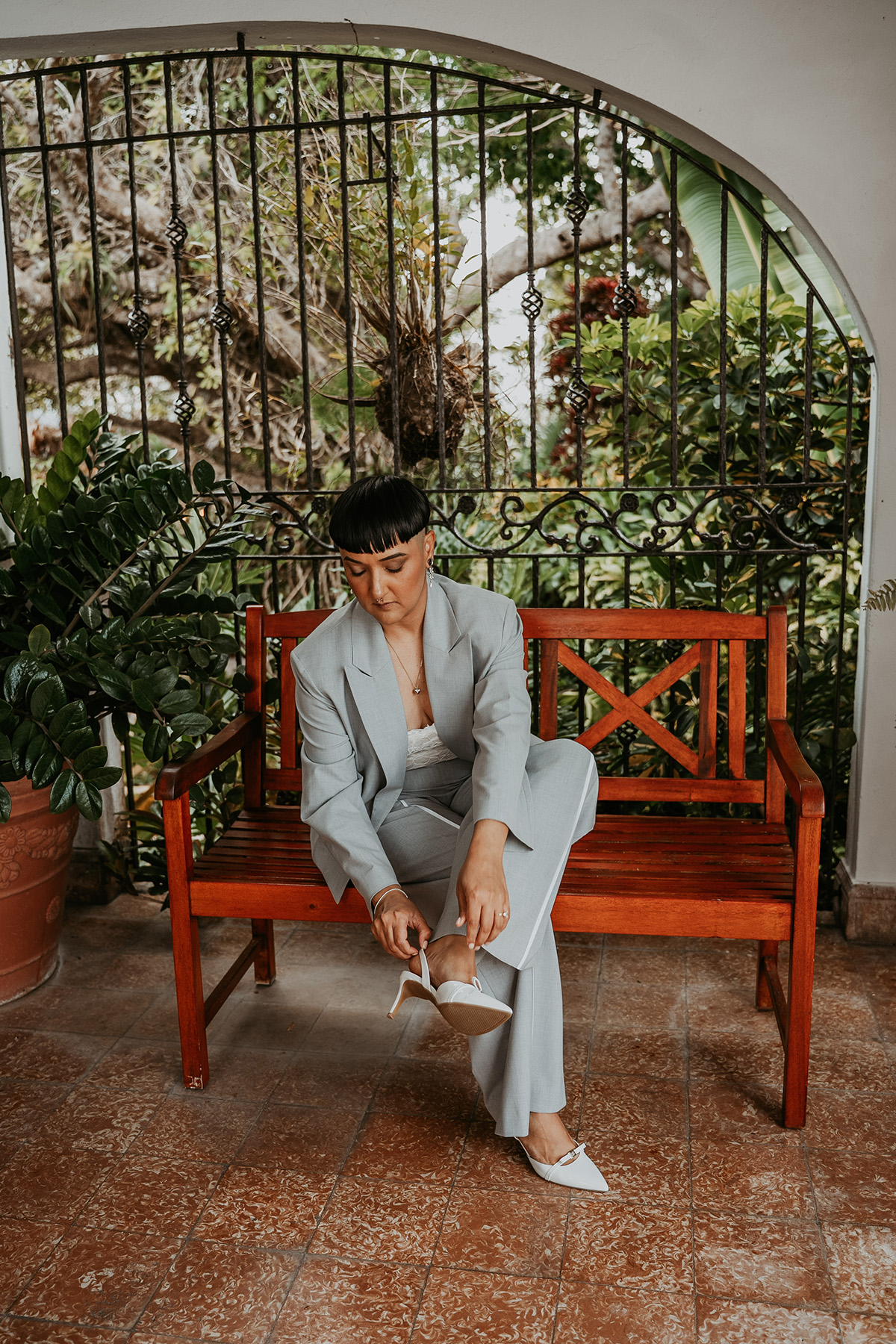 Masc bride getting ready before her wedding at Jardines del Castillo