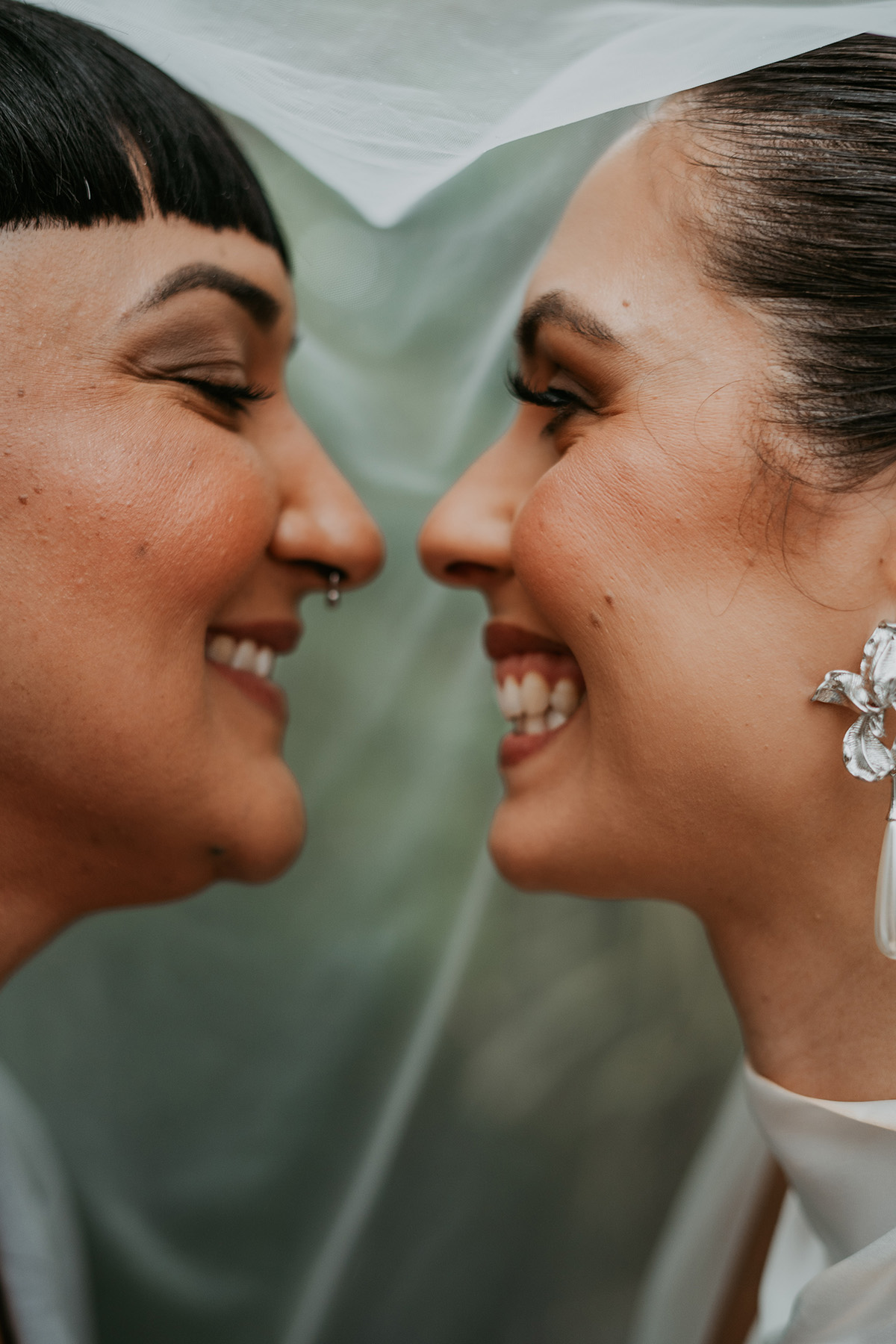 Close-up of newlywed lesbian couple laughing together after their Puerto Rico wedding