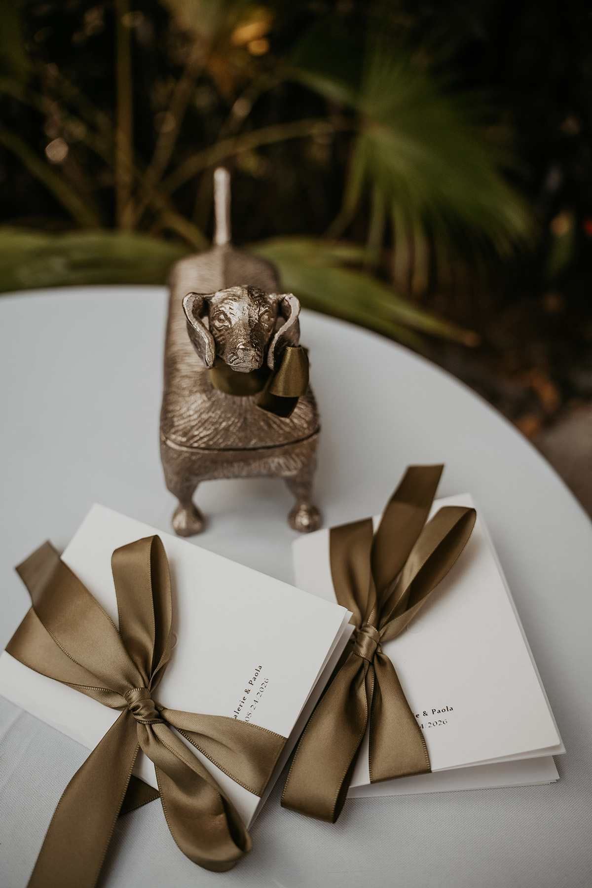 Wedding rings resting on a dachshund ring holder