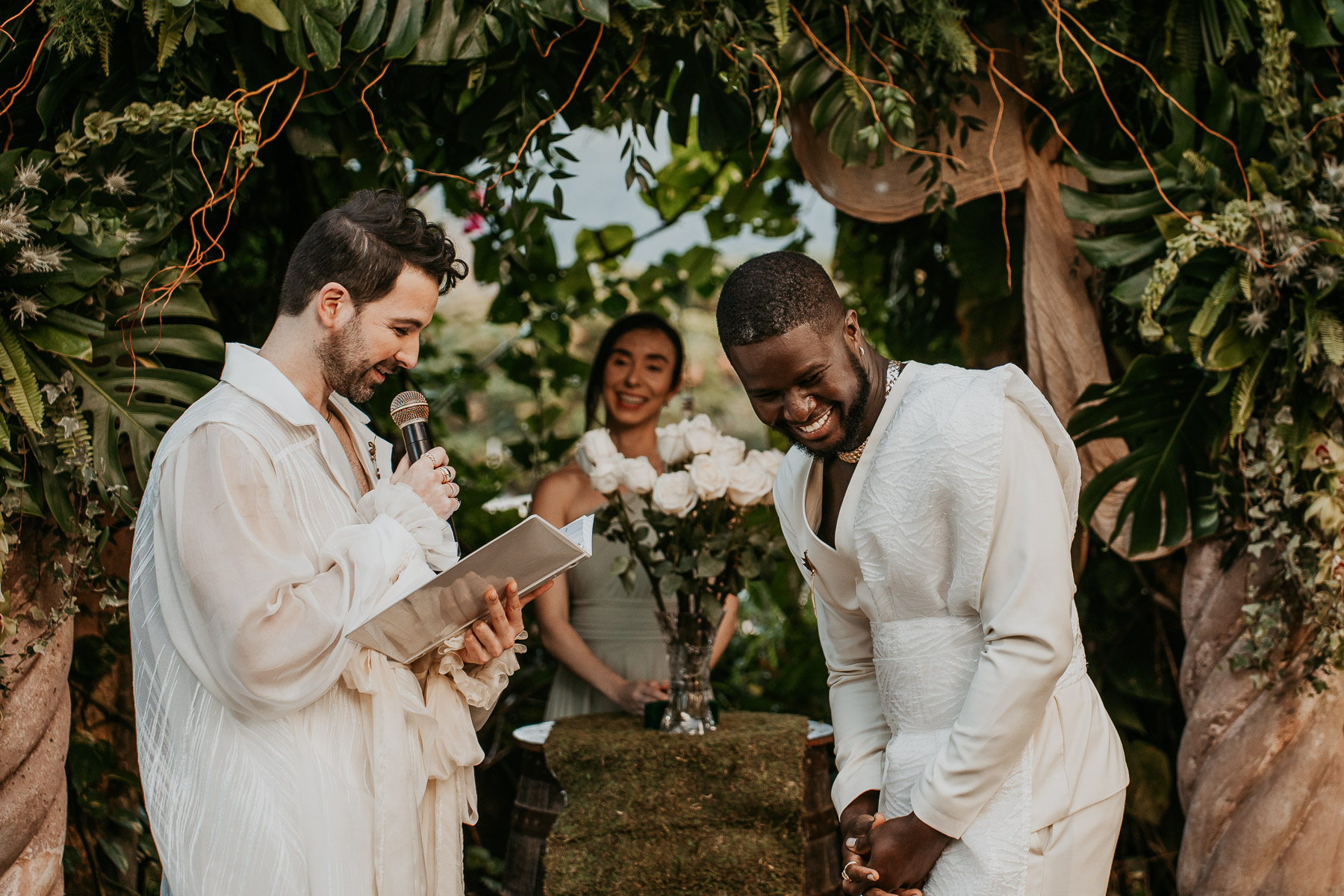 Two individuals exchanging vows at a vibrant outdoor ceremony.