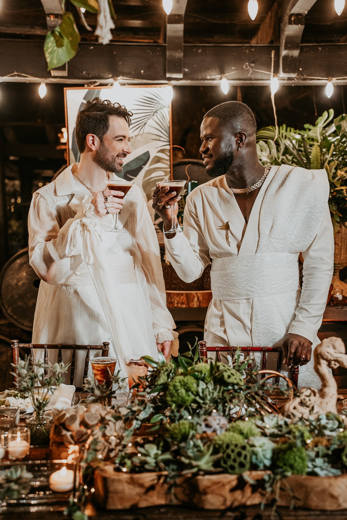 The couple smiling and toasting with coffee martinis, a personal and festive touch to their wedding day.