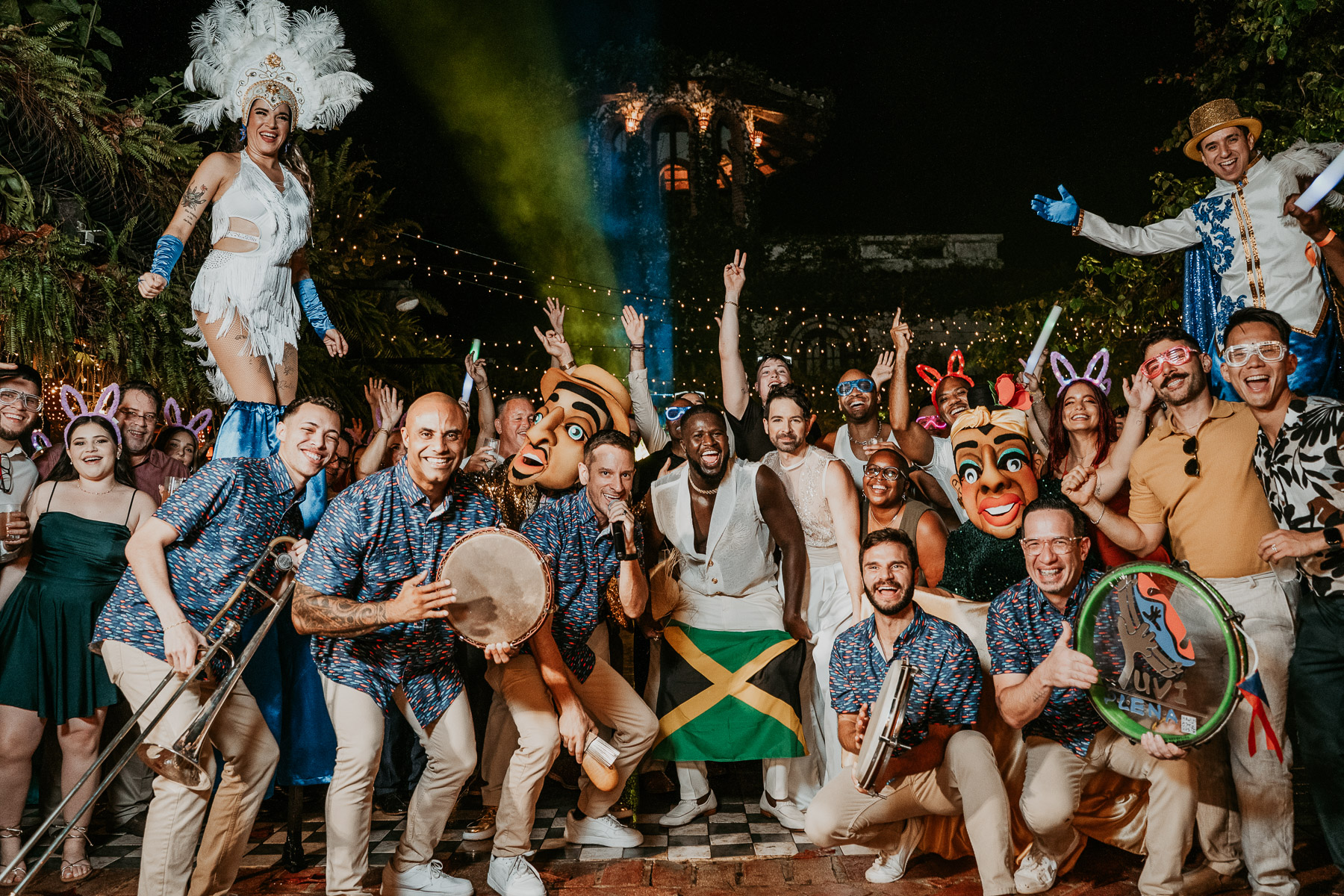 A lively Yuvi Plena band performing during the celebration, with guests dancing and waving the Haitian Flag in Celebration.
