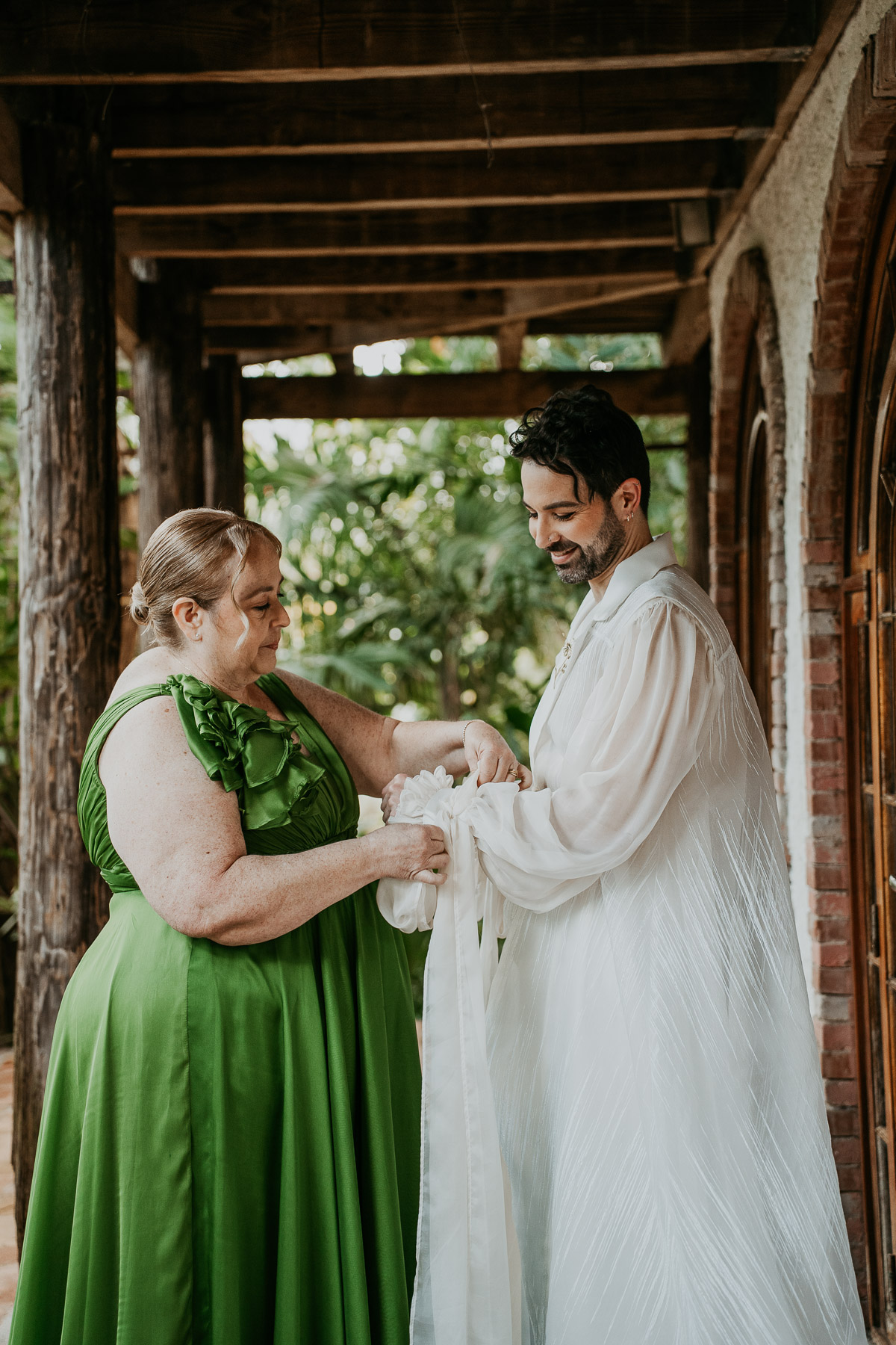 A tender portrait of one of the grooms with his mothe.