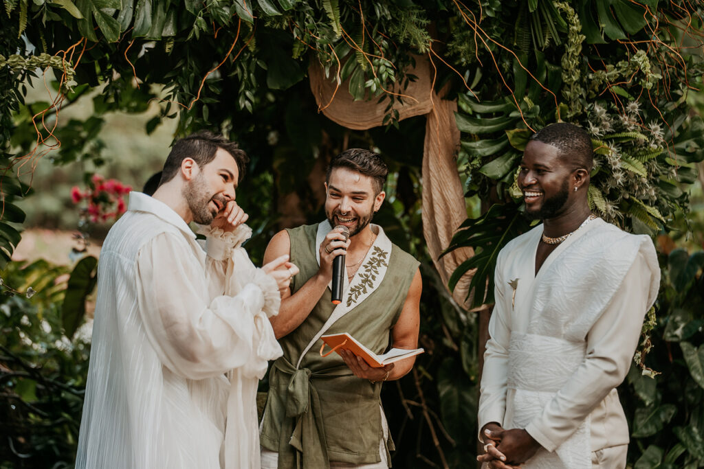 Interracial gay wedding candy moment during ceremony