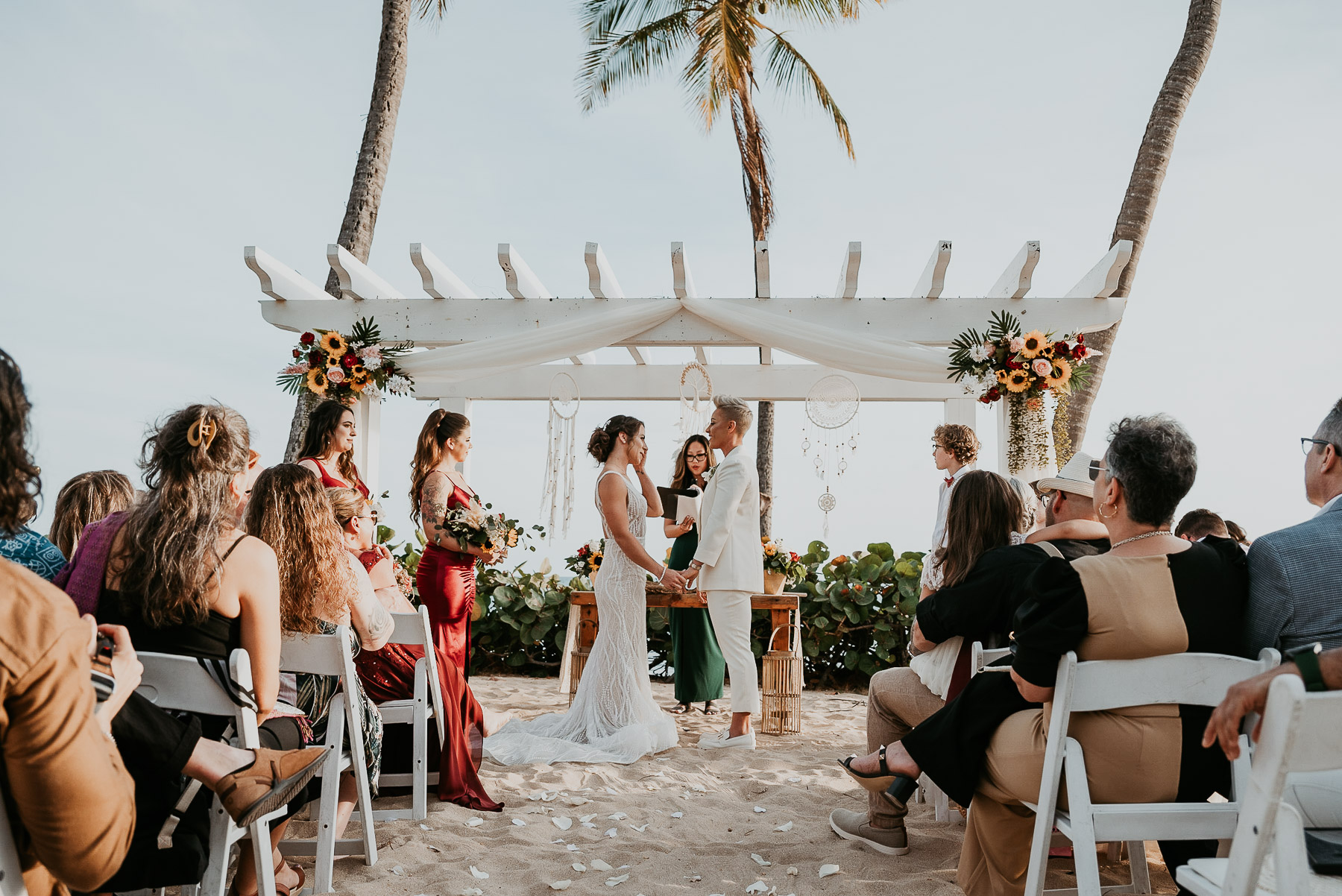 Oceanfront wedding ceremony setup with two brides at the altar.