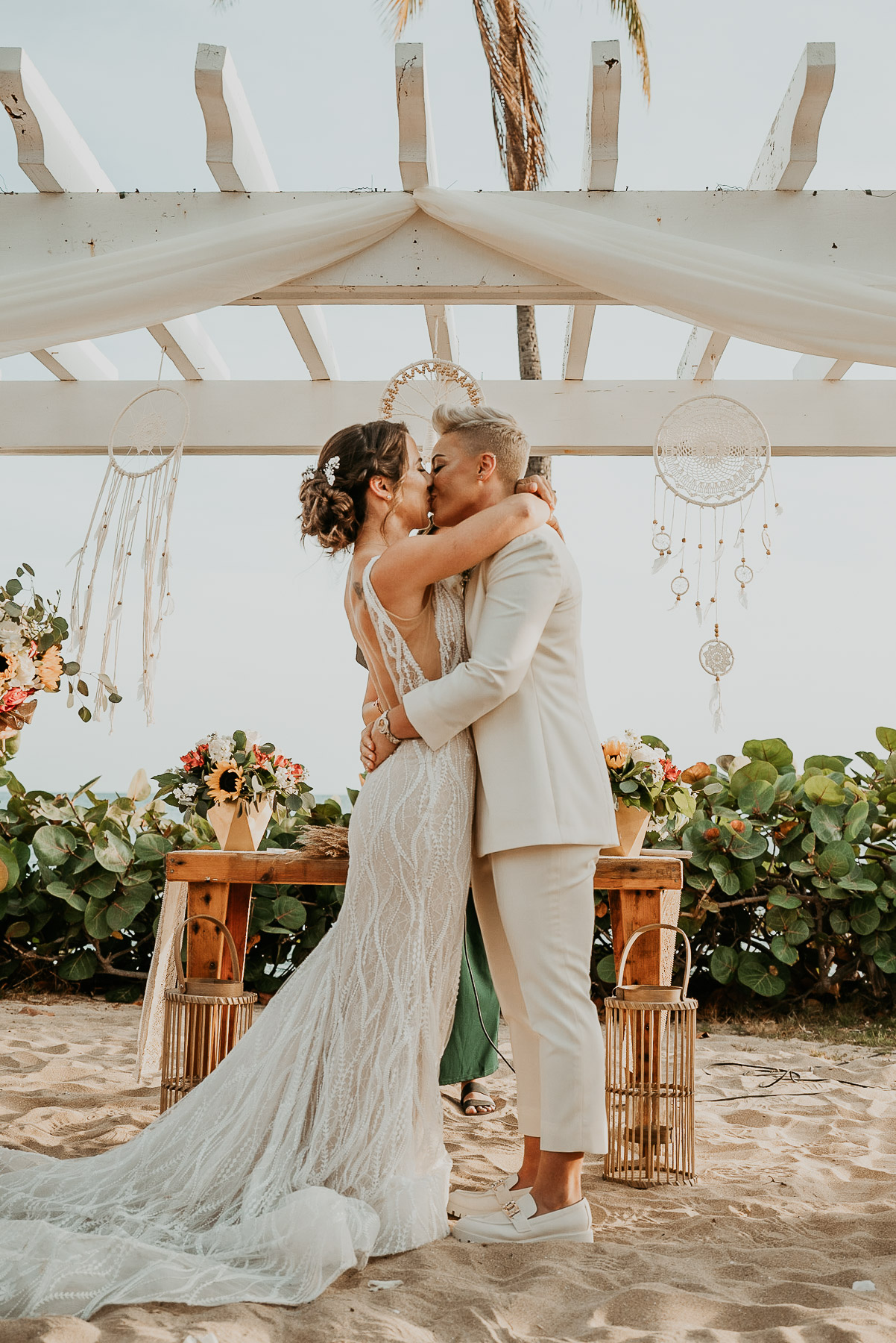 A celebratory kiss sealing the vows at the oceanfront altar.