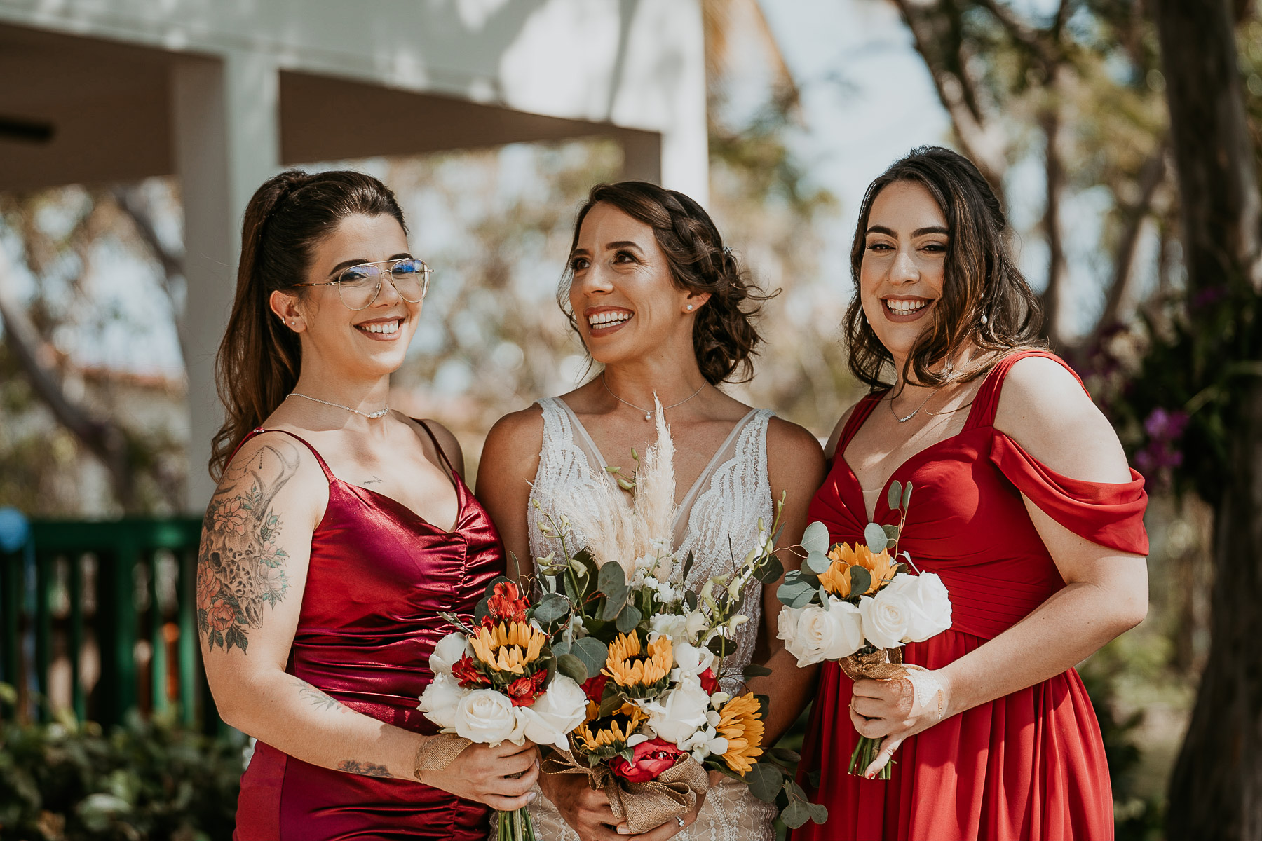 Candid moment between bride and bridesmaids at Copamarina Beach Resort LGBTQ+ Wedding.