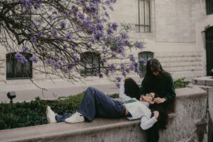 Nilka Gissell photographer with partner admiring flowers during lesbian couple session