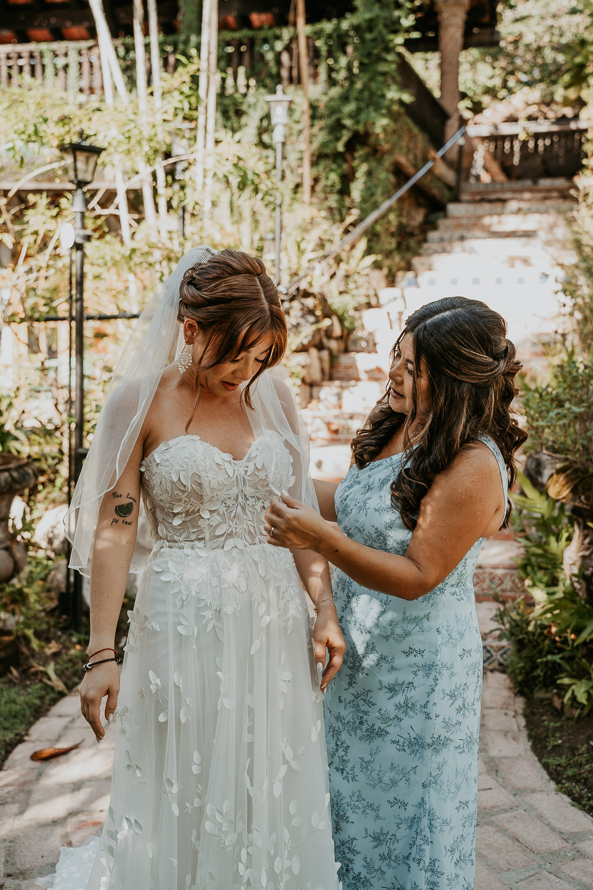 Bride and mom candid moment before wedding ceremony at Hacienda Siesta Alegre