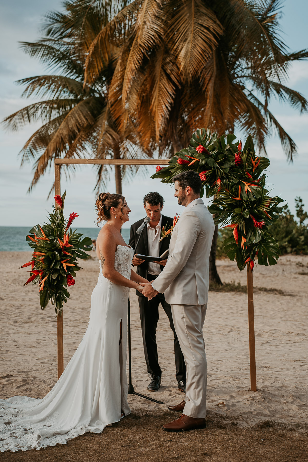 Couple holding hands during wedding ceremony