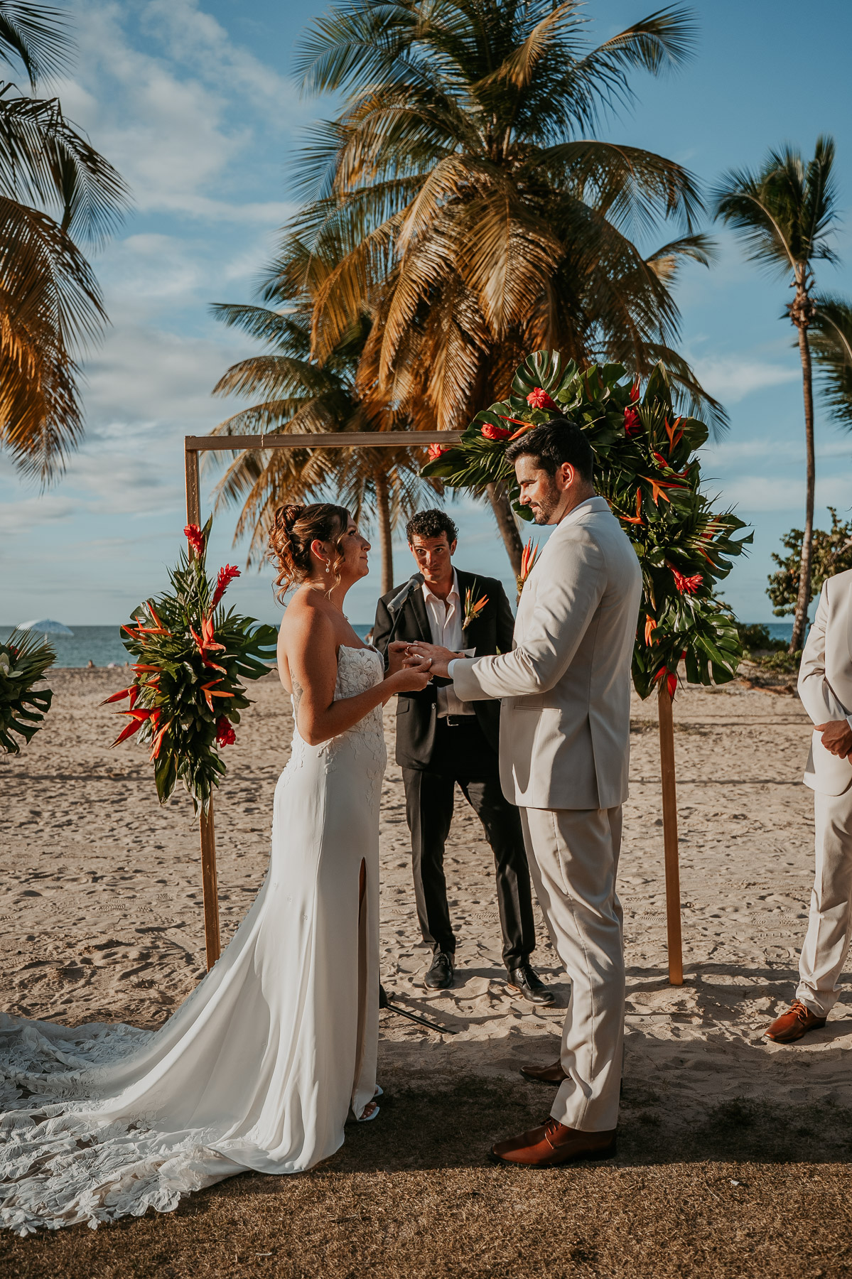 Couple exchanging vows during beach wedding ceremony