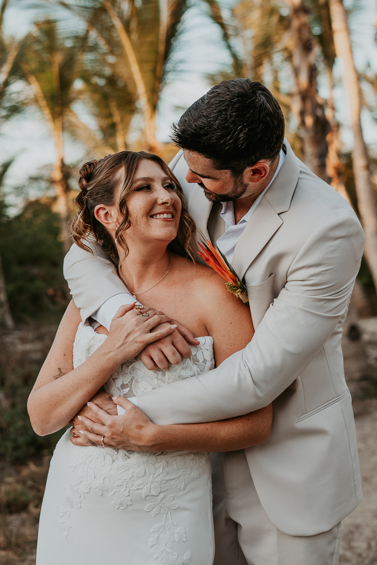 Close-up shot of candid embrace between newlywed couple