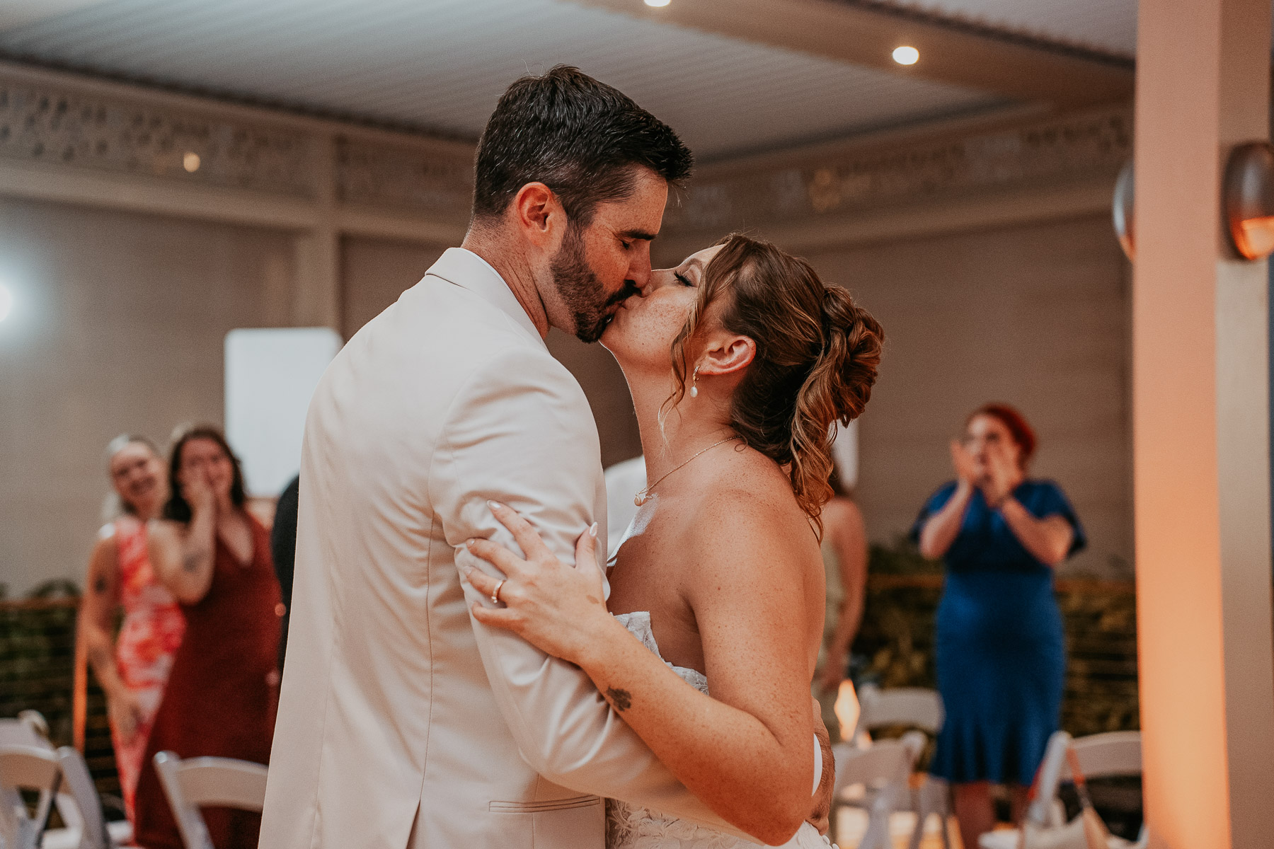 Couple kissing during entrance of wedding reception at Marriot Isla Verde