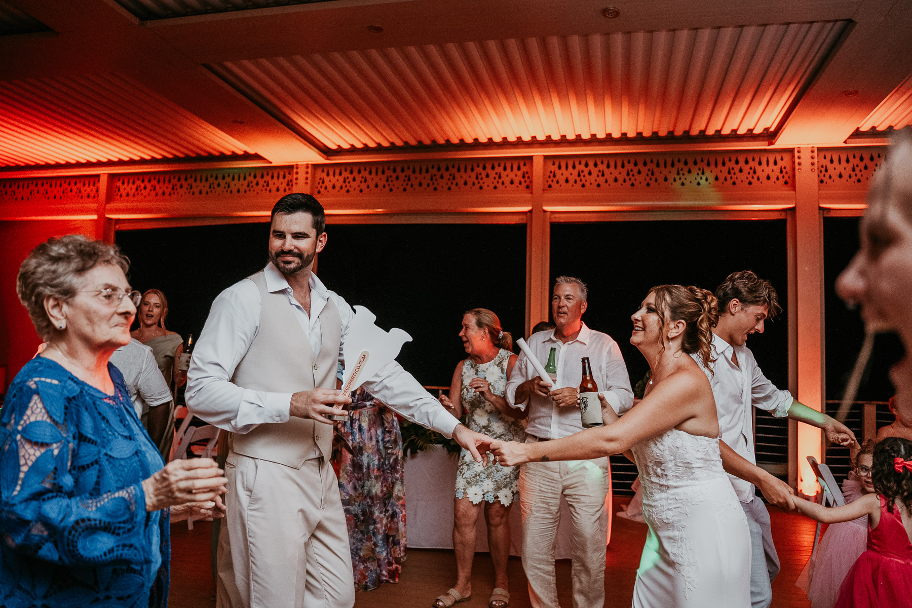 Newlywed couple dancing with friends and family