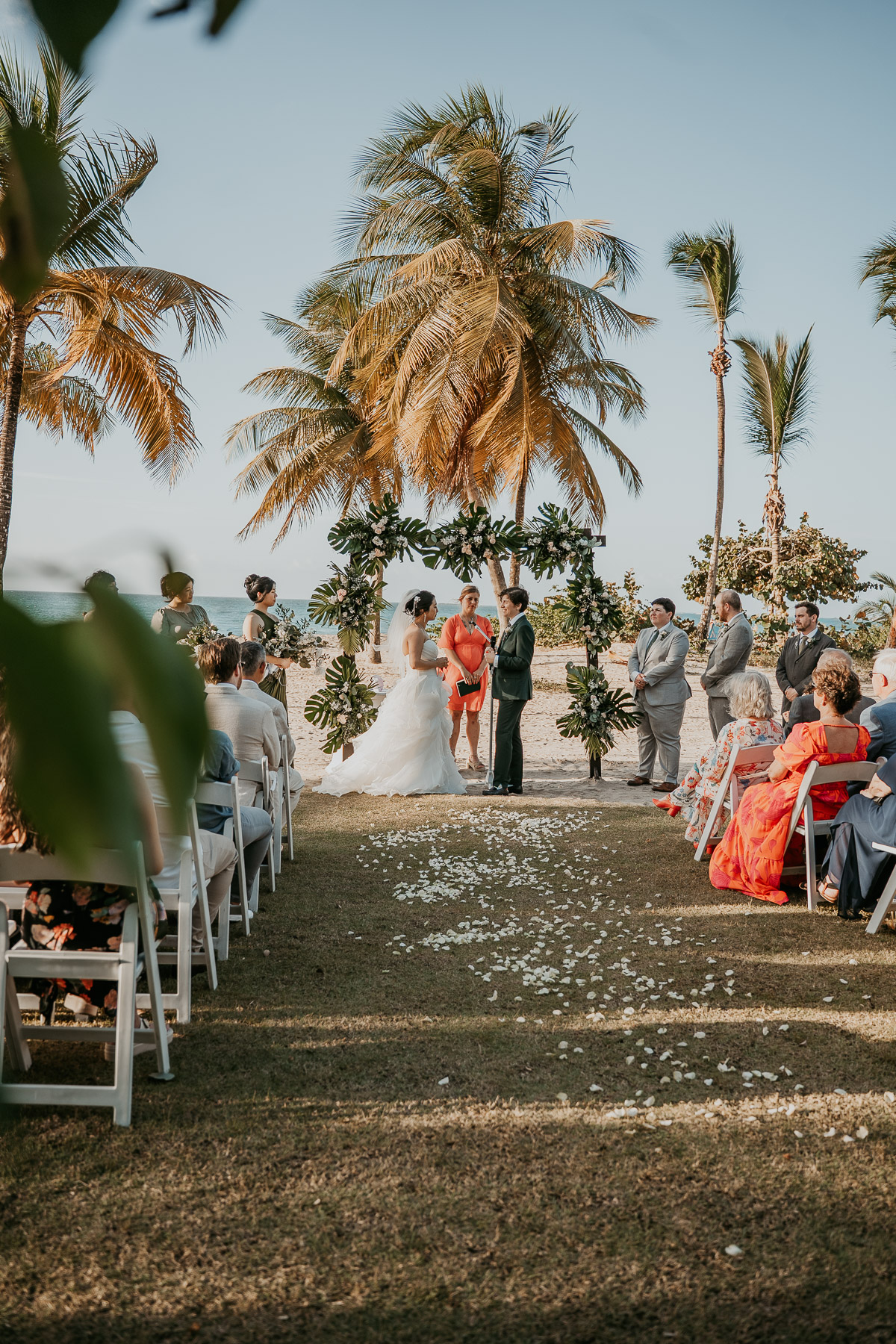 Vertical angle documentary photo of a lesbian wedding ceremony overlooking the Atlantic ocean.