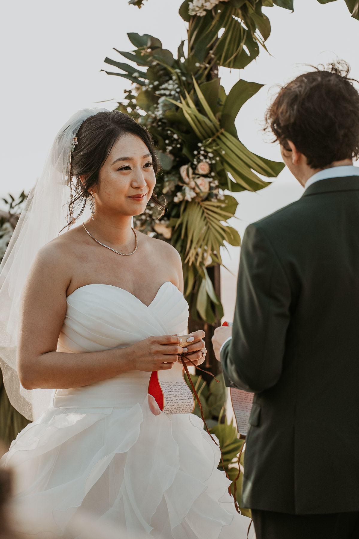 Candid photo of a lesbian wedding ceremony at beach wedding venue. 