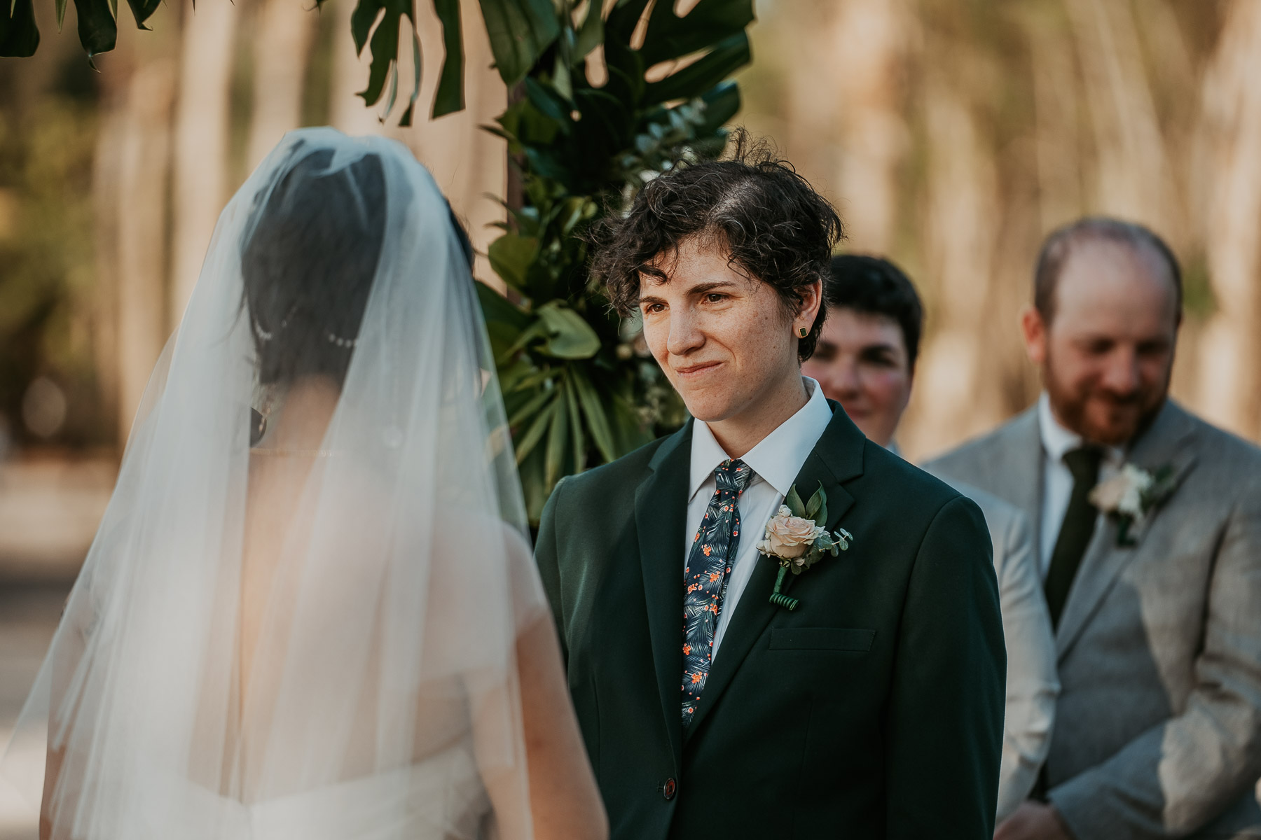 Candid photo of a lesbian wedding ceremony at beach wedding venue. 