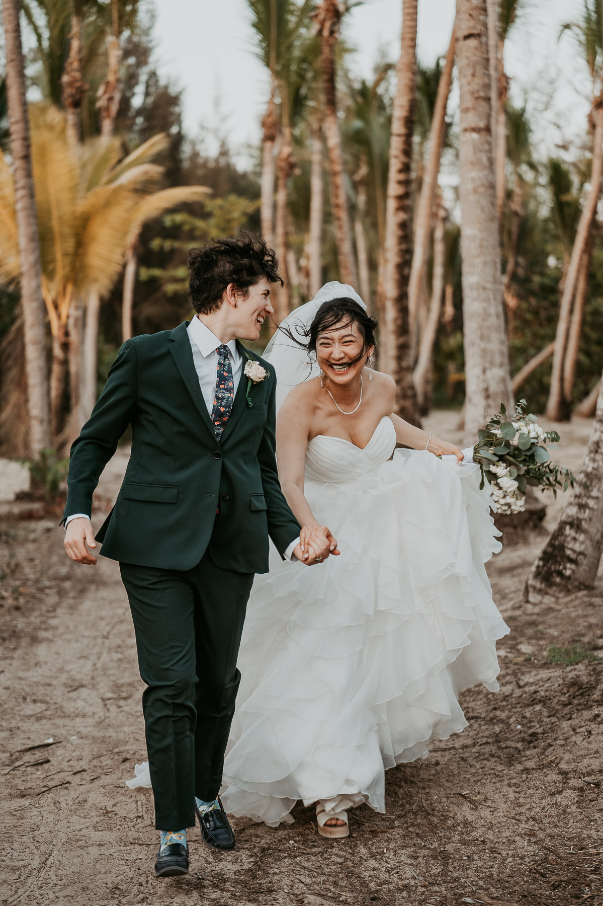 A fun, movement-filled shot of two brides running down the beach in Isla Verde.