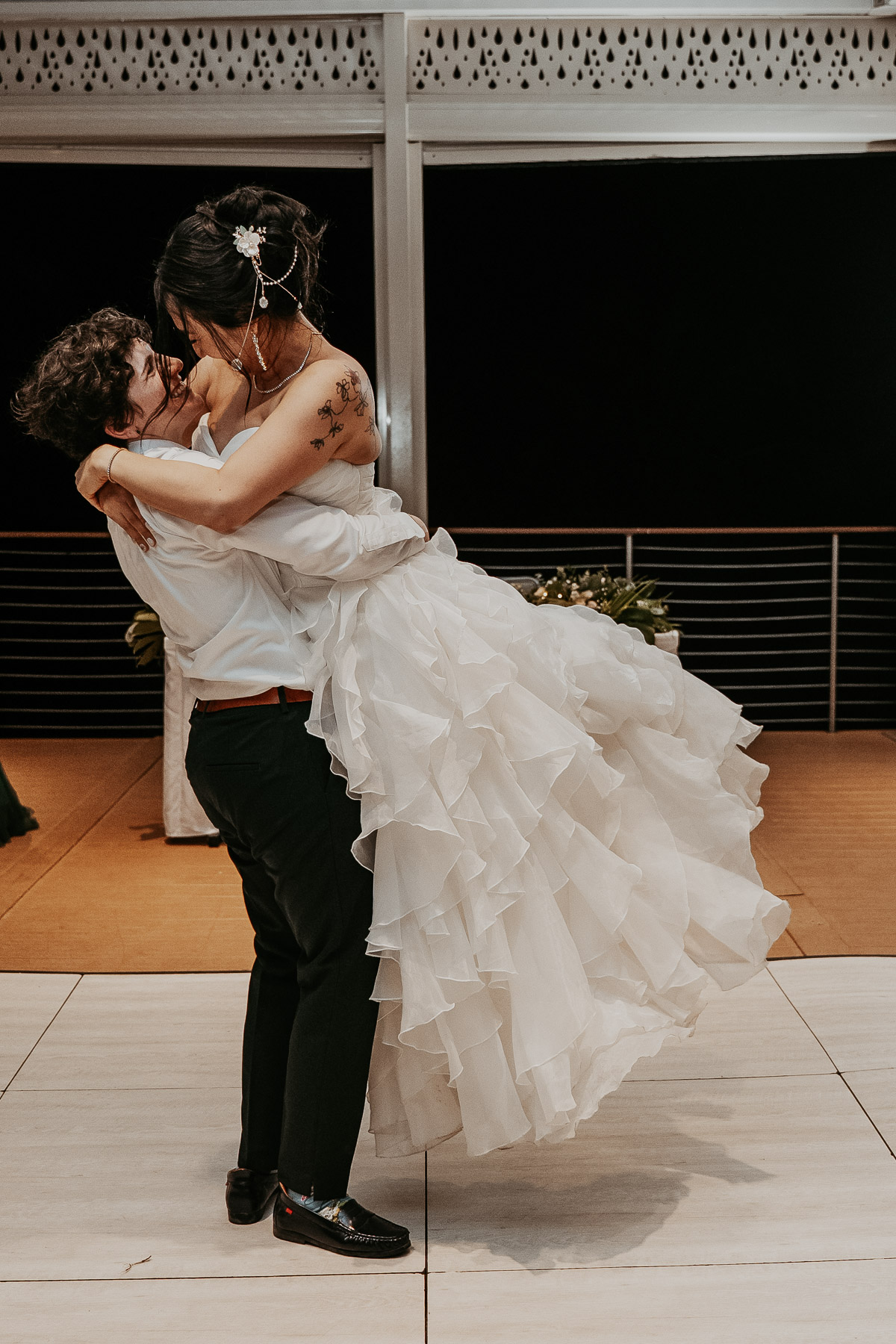 An intimate photo of the newlyweds holding each other closely during their first dance.