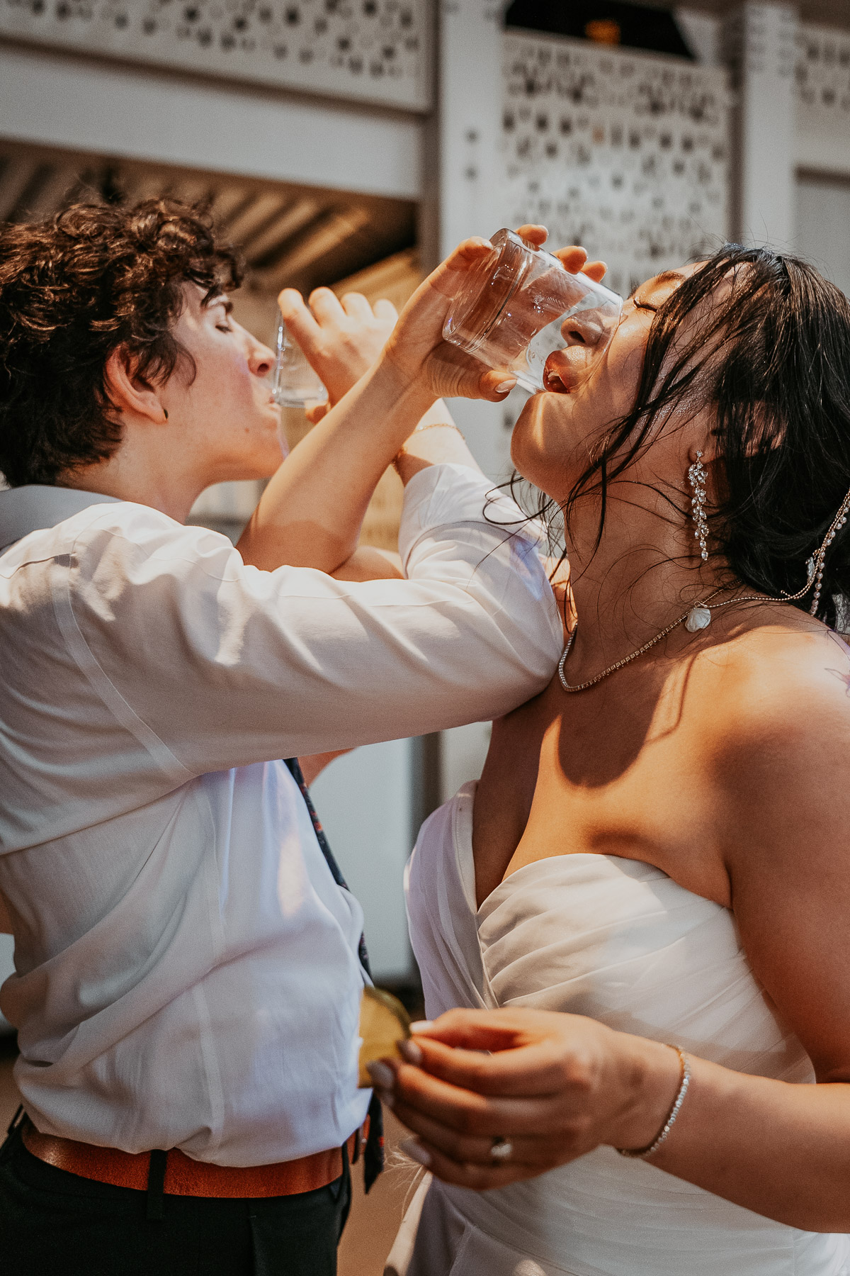 Couple doing a tequila shot during their LGBTQ+ Wedding at the Courtyard Marriot.