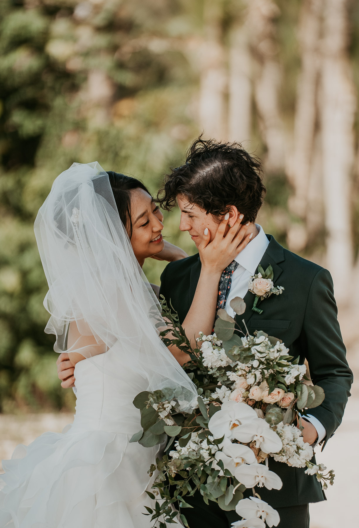 A quiet embrace between two brides during their private first look.