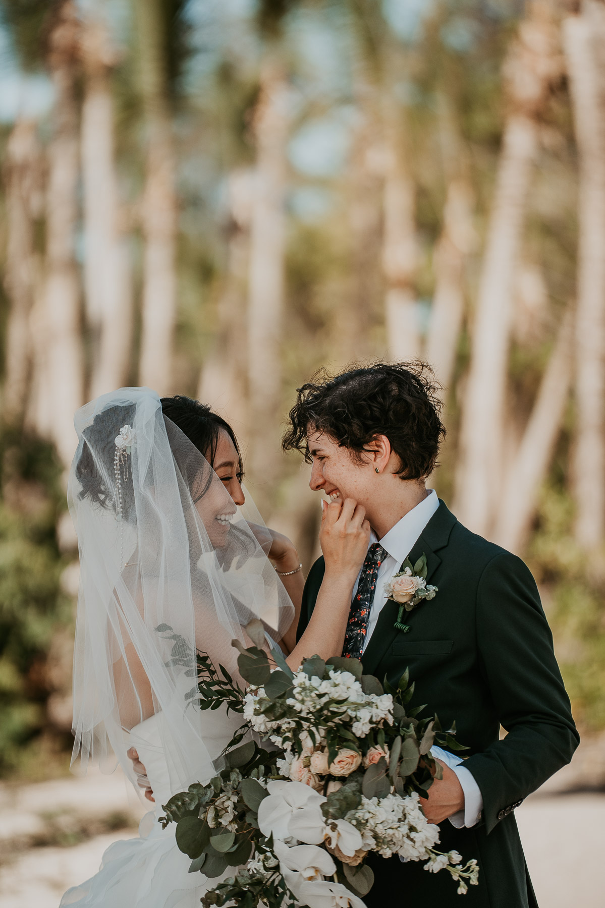 A quiet embrace between two brides during their private first look.