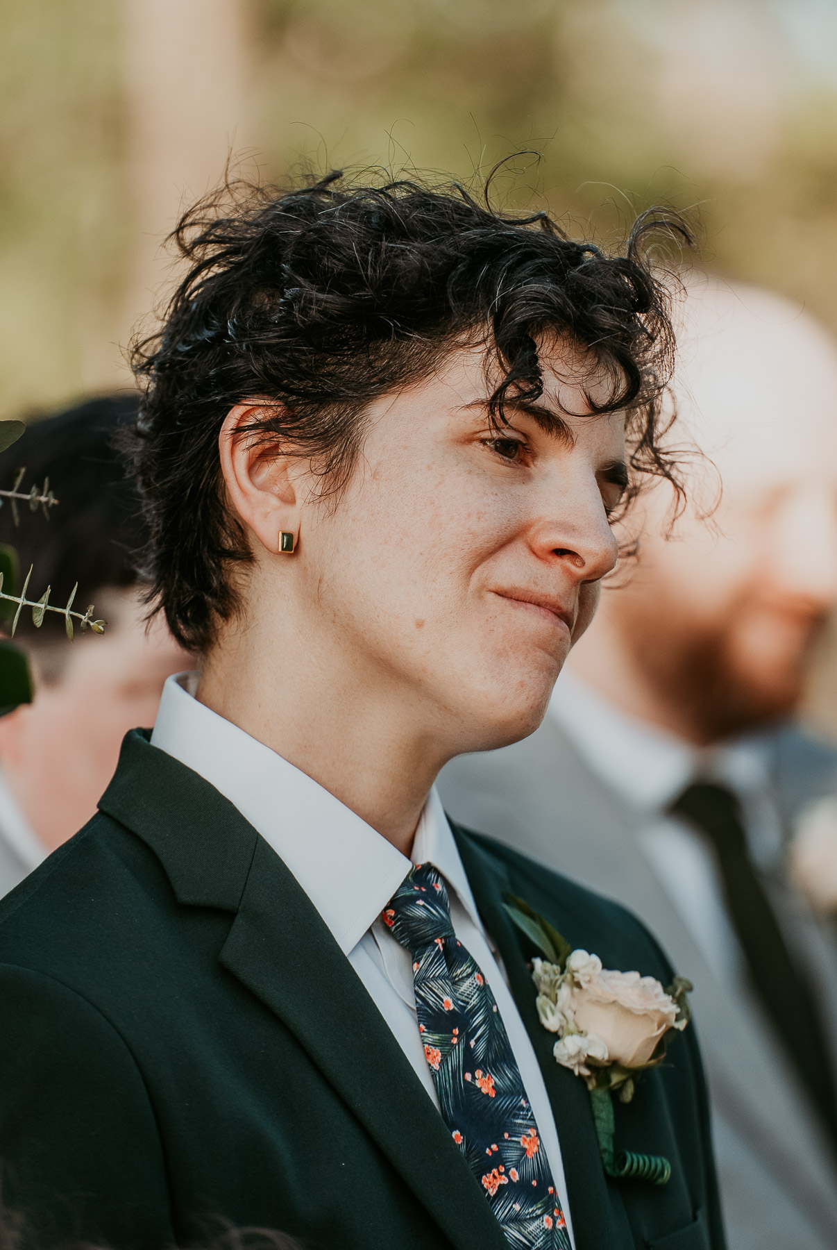 Candid emotional reaction of a masc lesbian seeing her soon to be bride walking down the isle. 