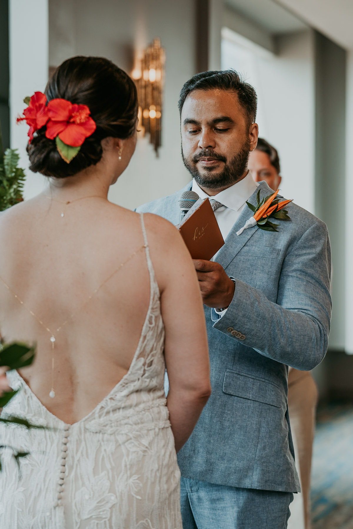Couple exchanging vows surrounded by candlelight inside La Concha.