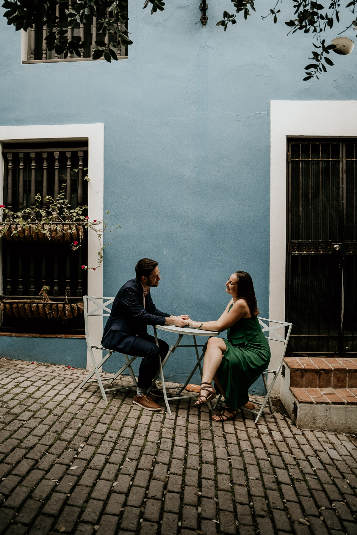 Romantic overcast day at Old San Juan with couple sitting down looking at each other.