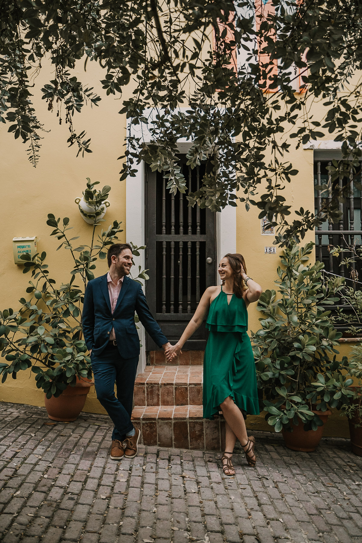 A romantic, rainy day in Old San Juan with a couple walking hand-in-hand on cobblestone streets.