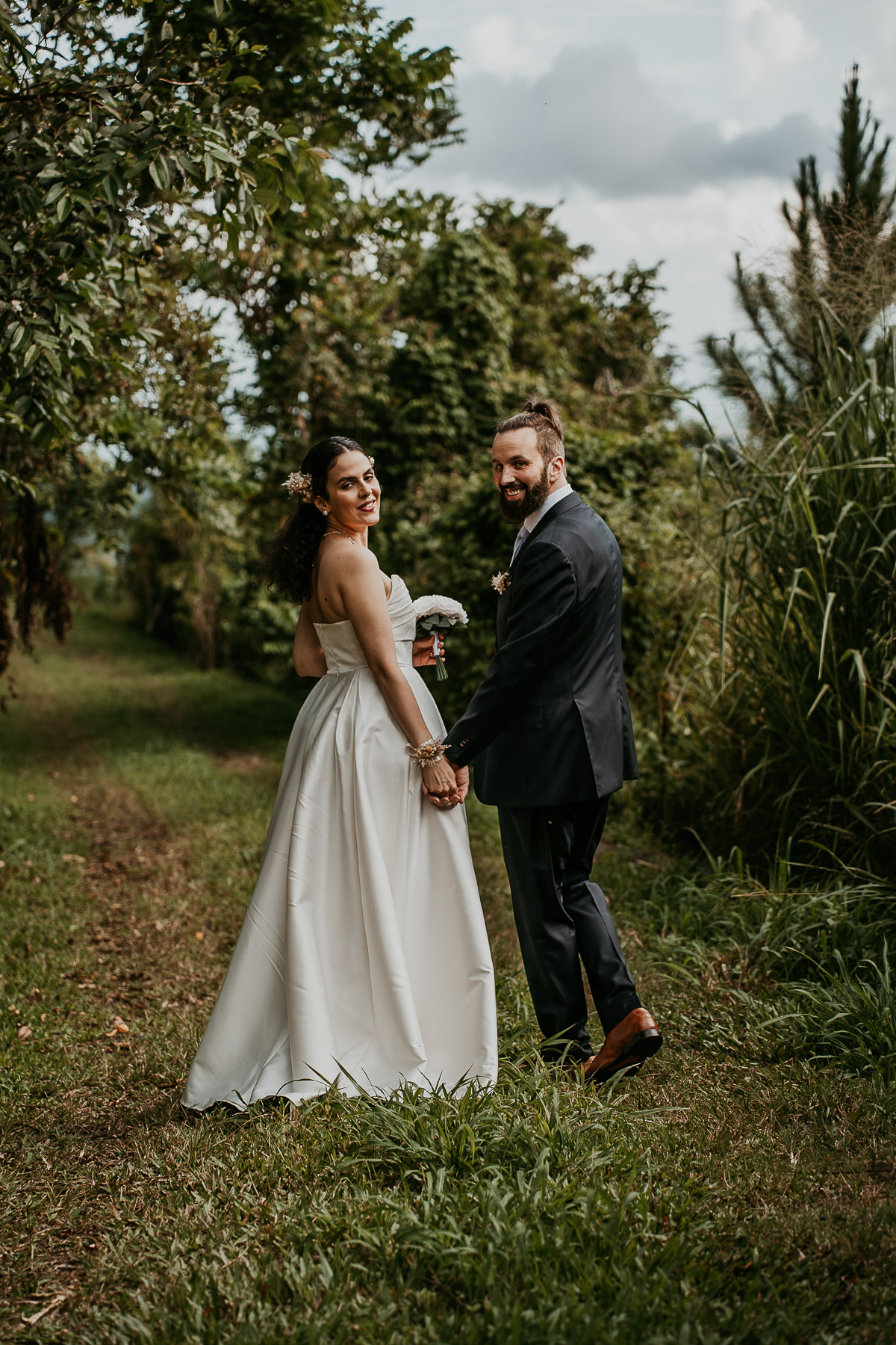 Candid moment of the couple walking hand-in-hand through the trails in Cayey.