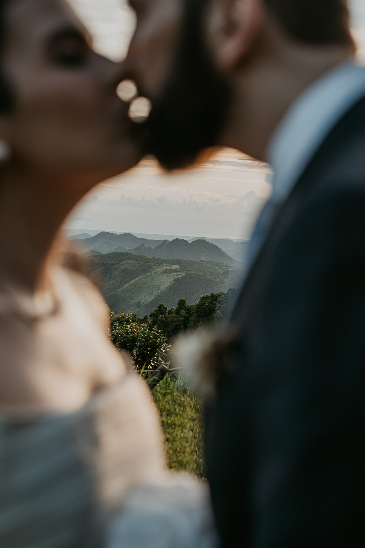 Wide-angle view of the ceremony in Cayey with the mountains and misty skies.