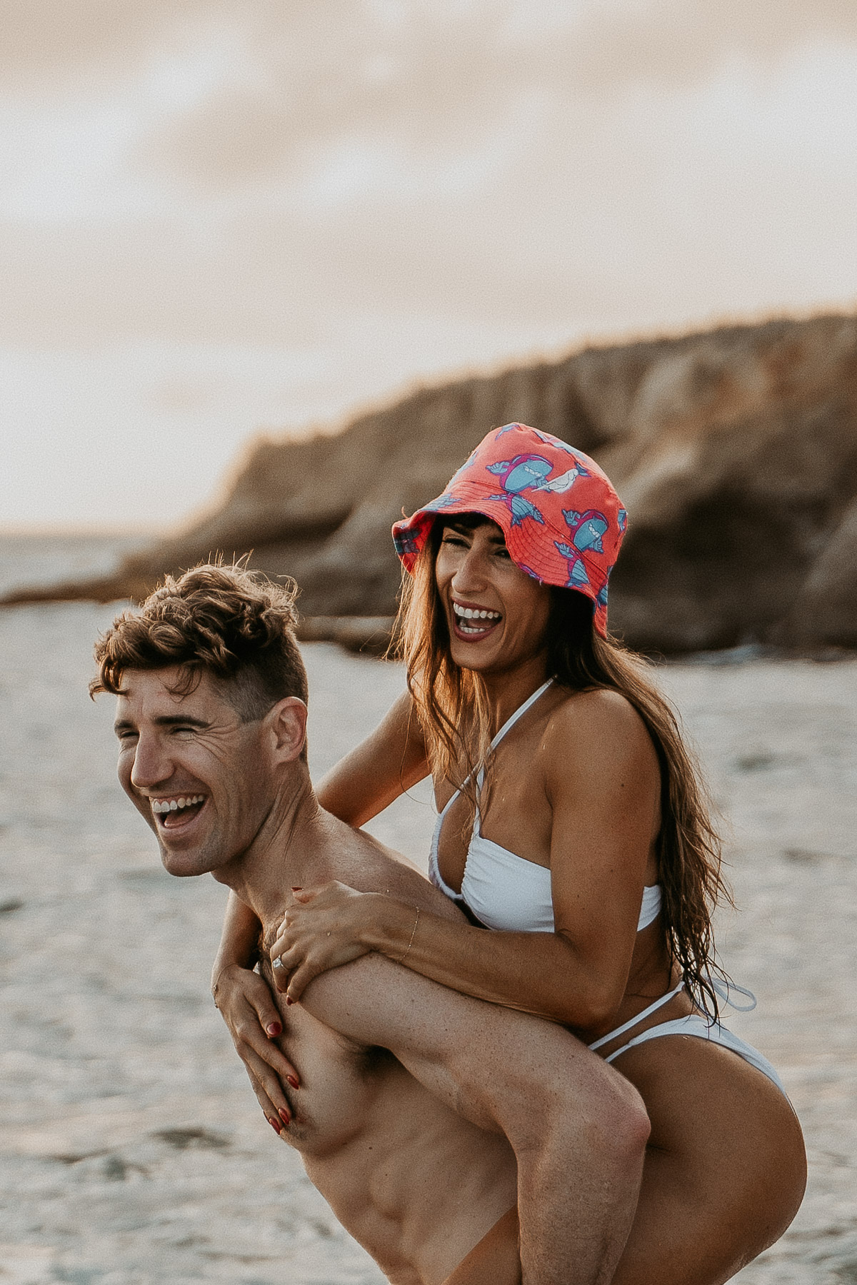 Playful and carefree moment of a couple at the beach.