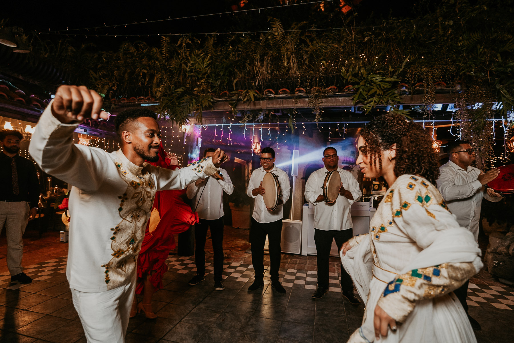 Bride and groom have fun dancing with pleneros.