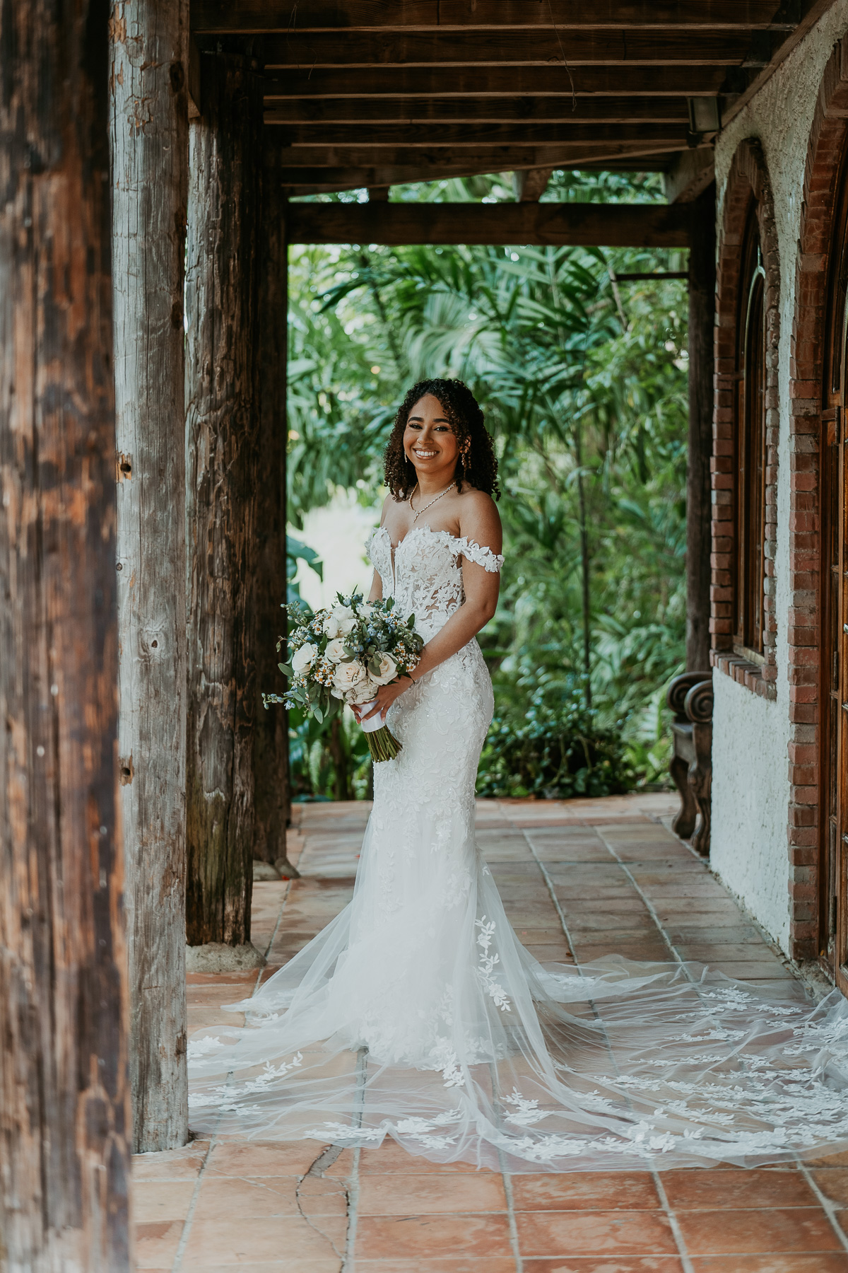 Bride posing outside of Flamboyan room at Hacienda Siesta Alegre.