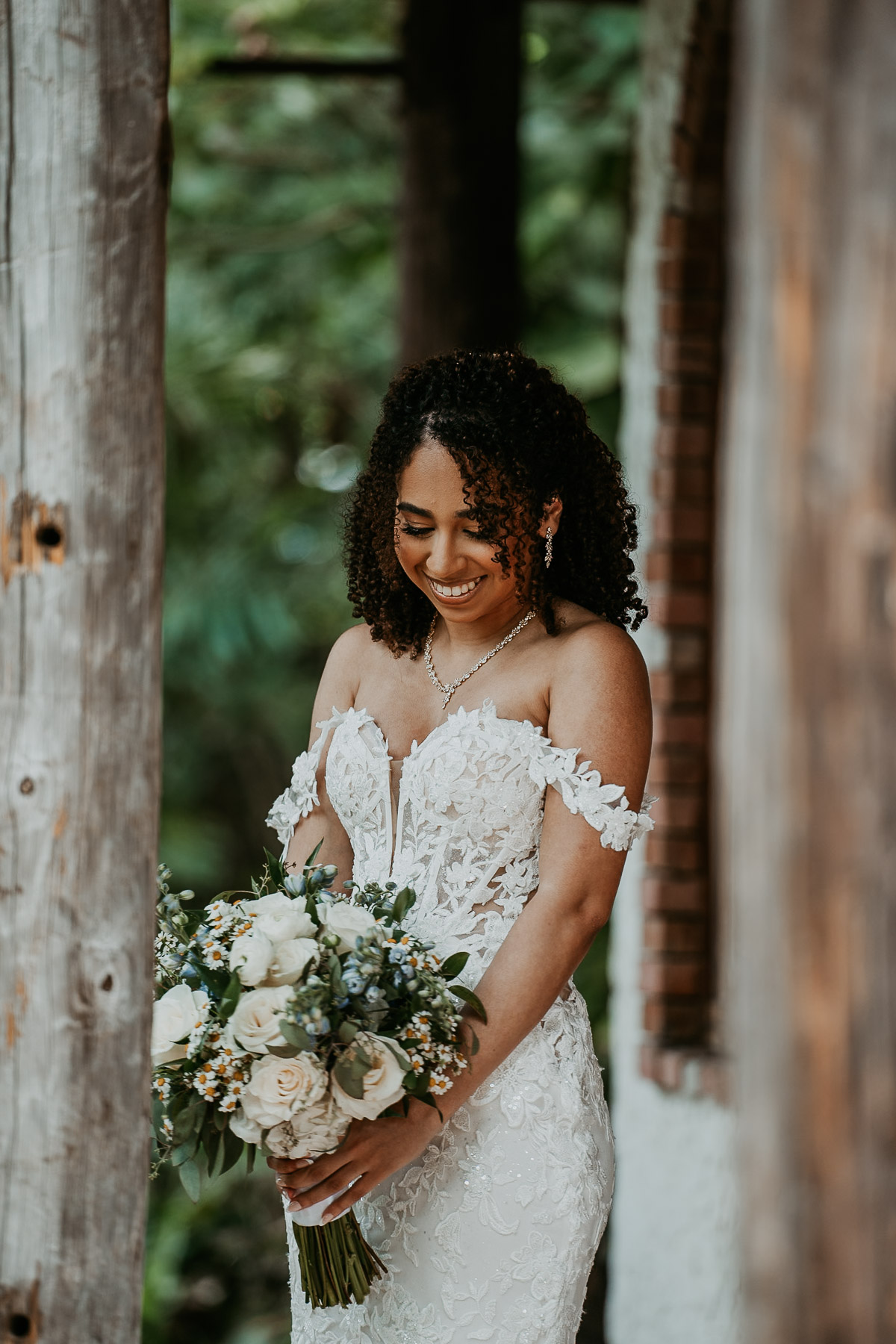 Candid portrait of bride holding a white bouquet of flowers at Hacienda Siesta Alegre.