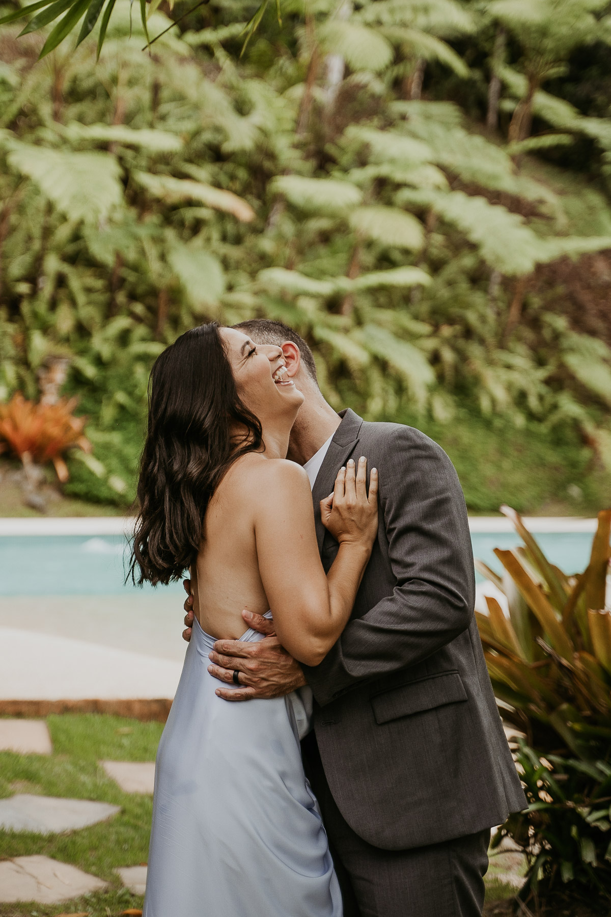 Couple embracing with the gardens of Mont Carpe Diem as a backdrop in Puerto Rico.