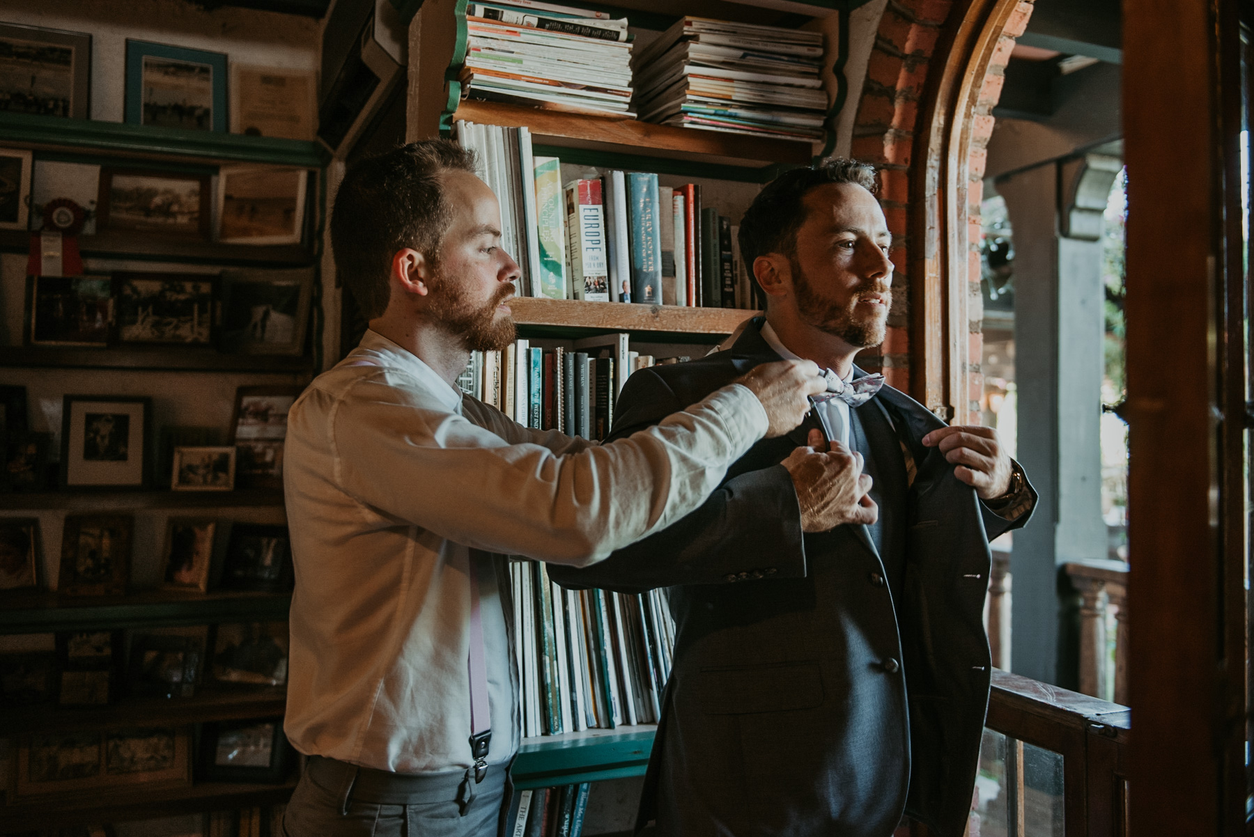 Groom getting ready at the library of Hacienda Siesta Alegre in Rio Grande.