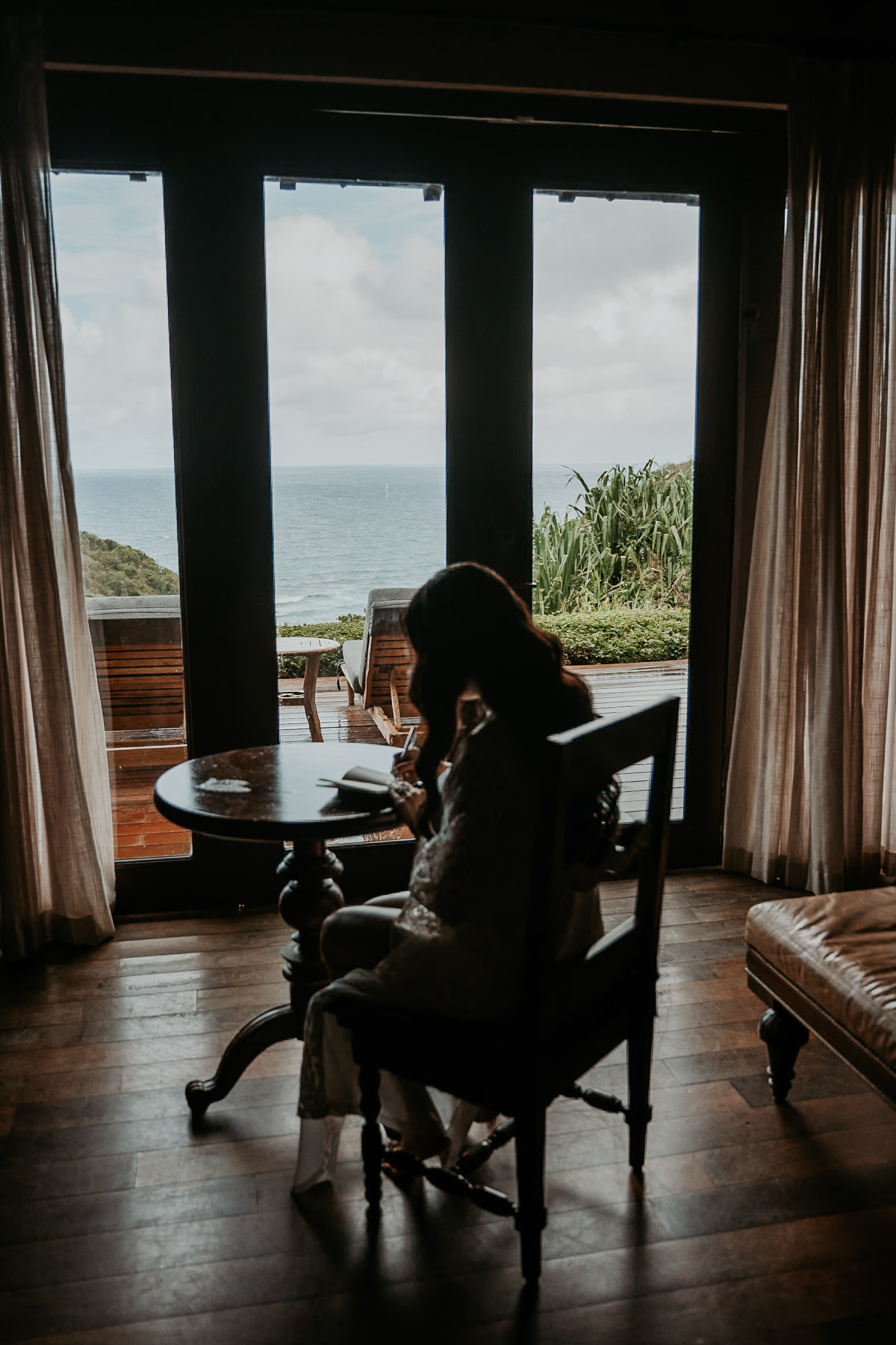 Bride alone in her room writing her vows at Royal Isabela wedding.