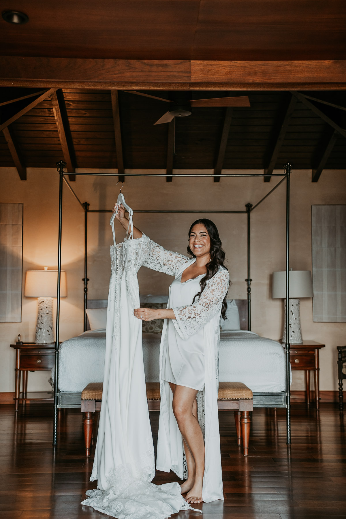 Bride smiling holding her wedding dress for her Royal Isabela wedding in Puerto Rico.