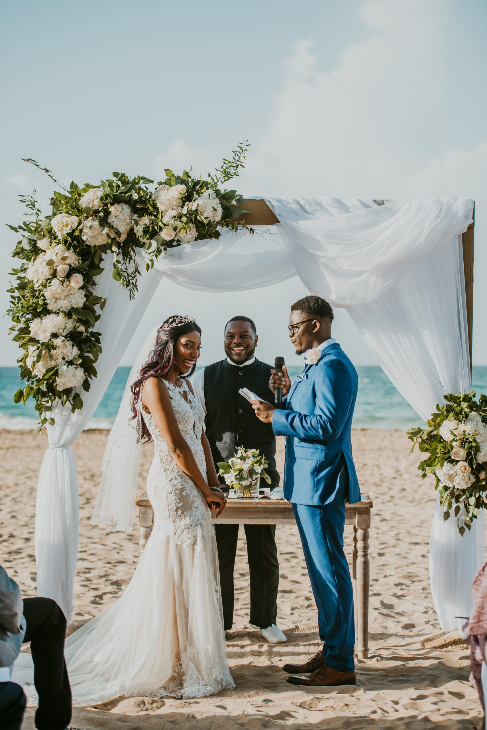 Couple exchanging vows during a non-denominational beach wedding ceremony at La Concha Resort, with the ocean as a stunning backdrop."