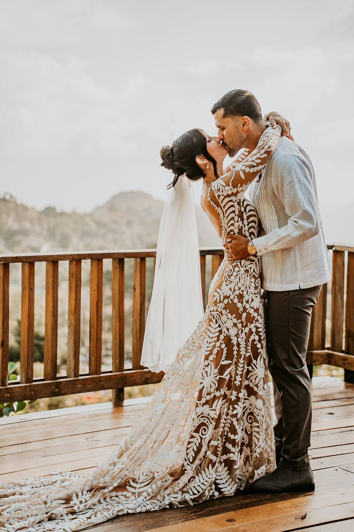 First kiss during laid back wedding at El Pretexto in Cayey Puerto Rico with mountain views