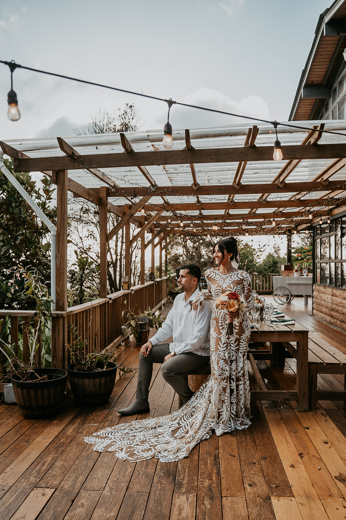 Couple sitting on long table after their mountain wedding venue El Pretexto Puerto Rico 